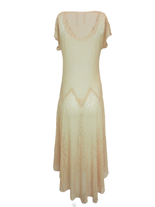 A vintage 1920s light beige lace maxi dress with short flutter sleeves, a scoop neckline, and a scalloped zigzag pattern around the waist