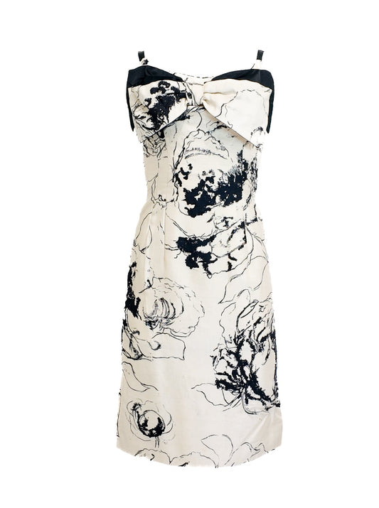 White dress with black floral pattern on a white background