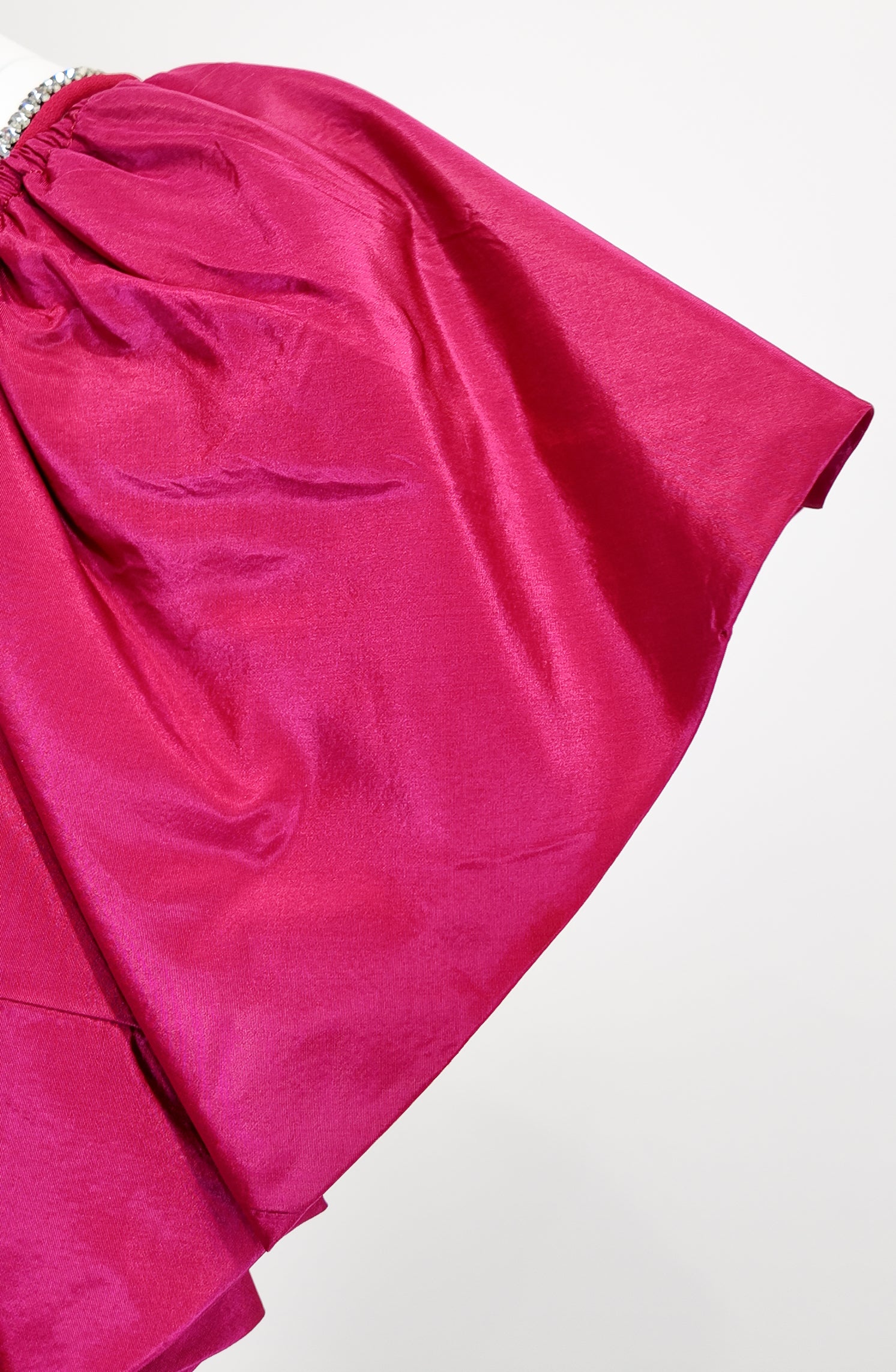 Close-up of a bright pink fabric with a white background