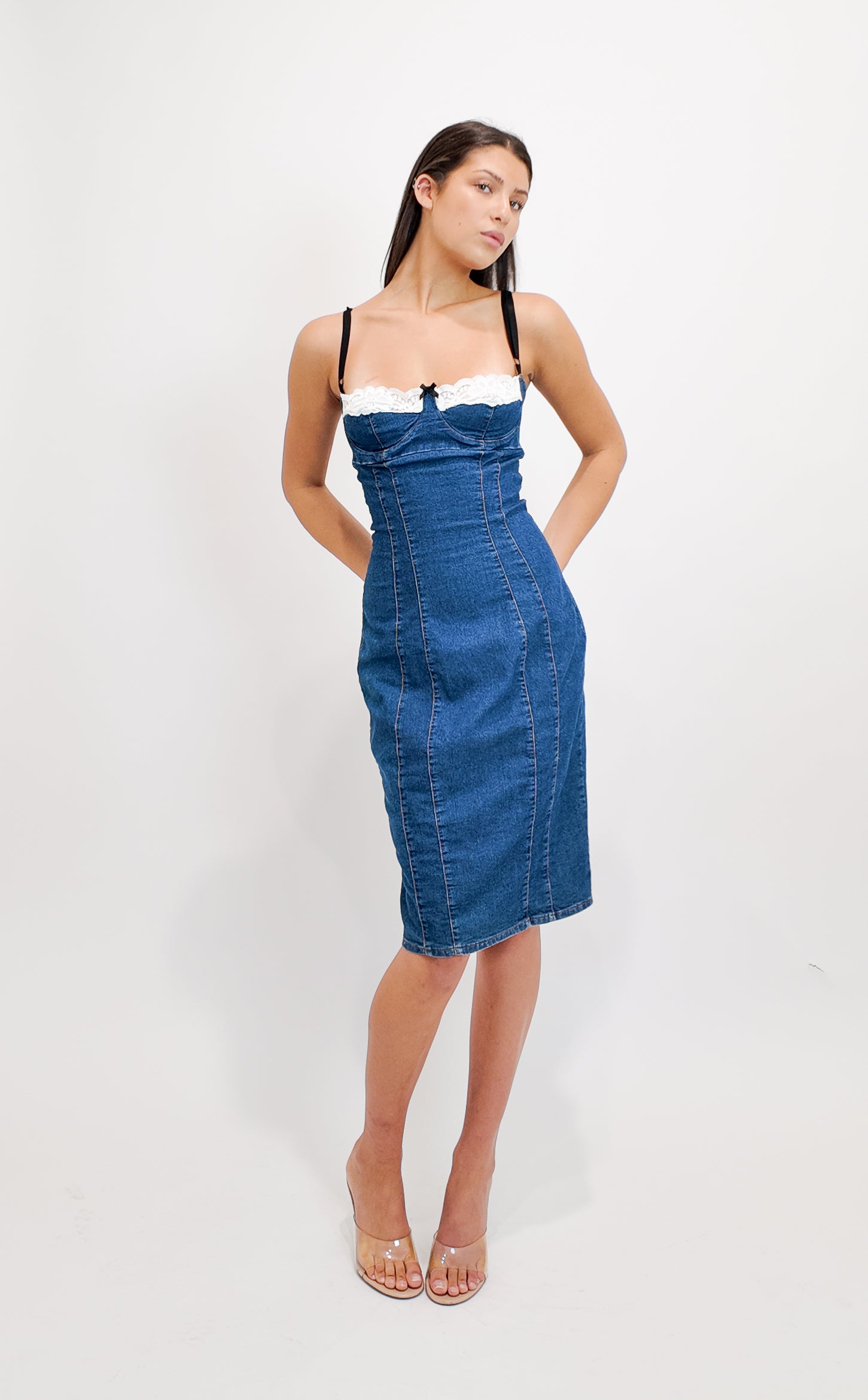 Woman wearing a D&G 2000s blue denim dress with white top on a white background