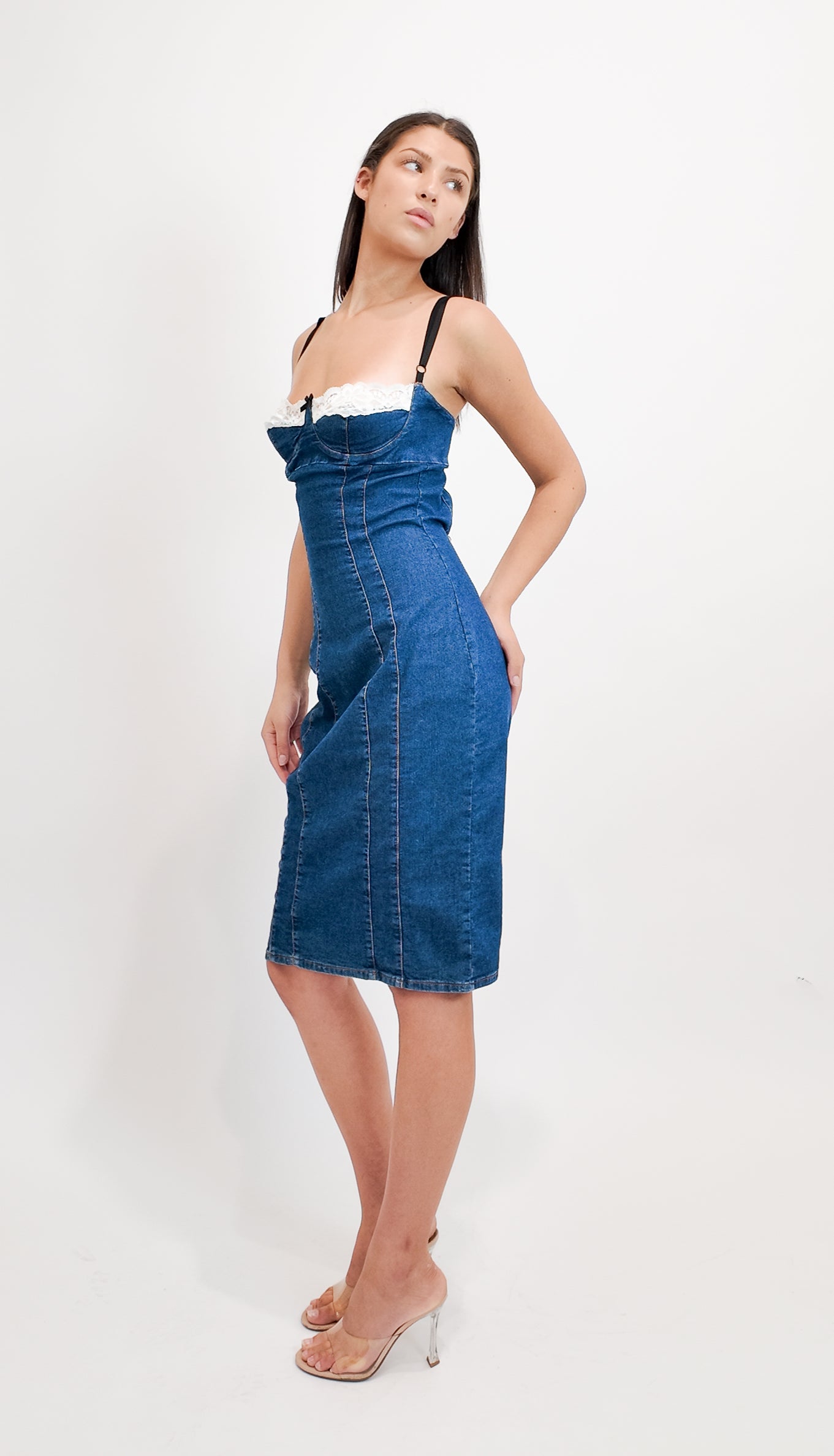 Woman wearing a denim dress against a white background