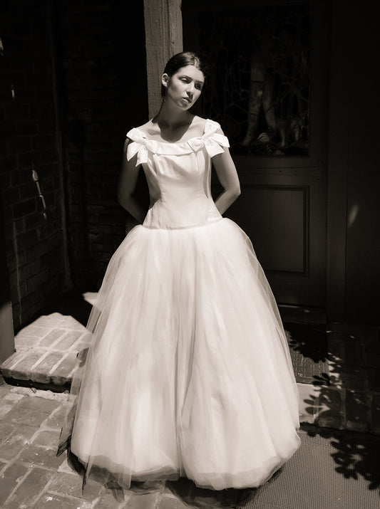 Woman in a Bob Evans for Neiman Marcus 1997 white wedding dress standing outdoors.