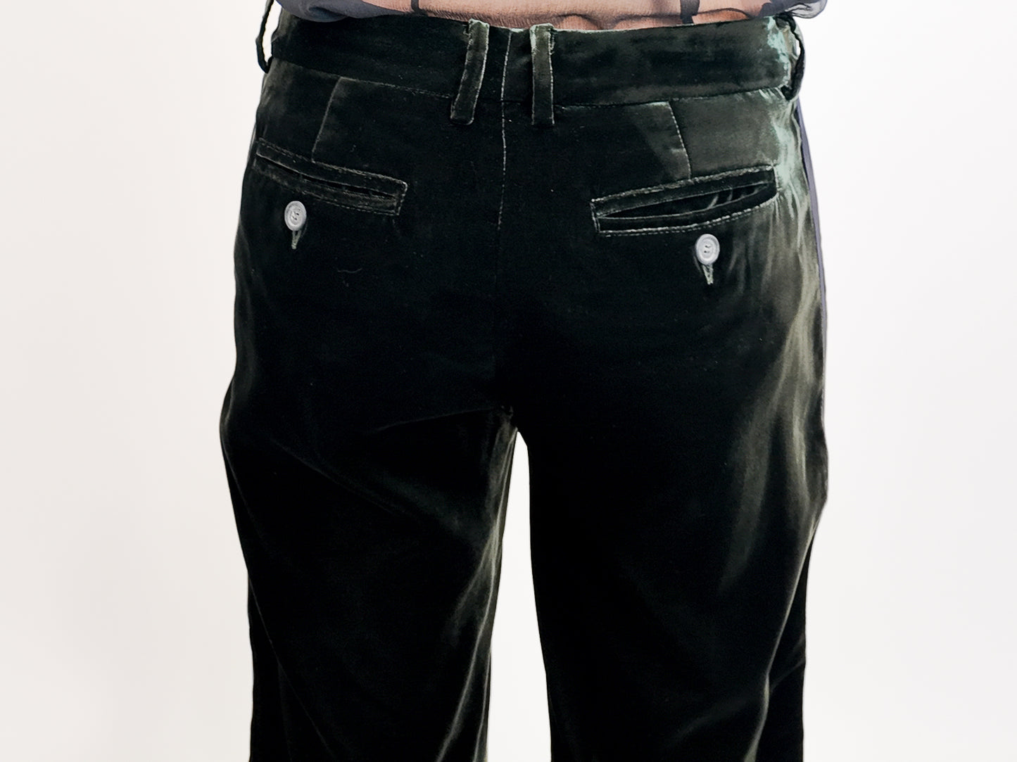 Green velvet pants with buttons and back pockets on a white background