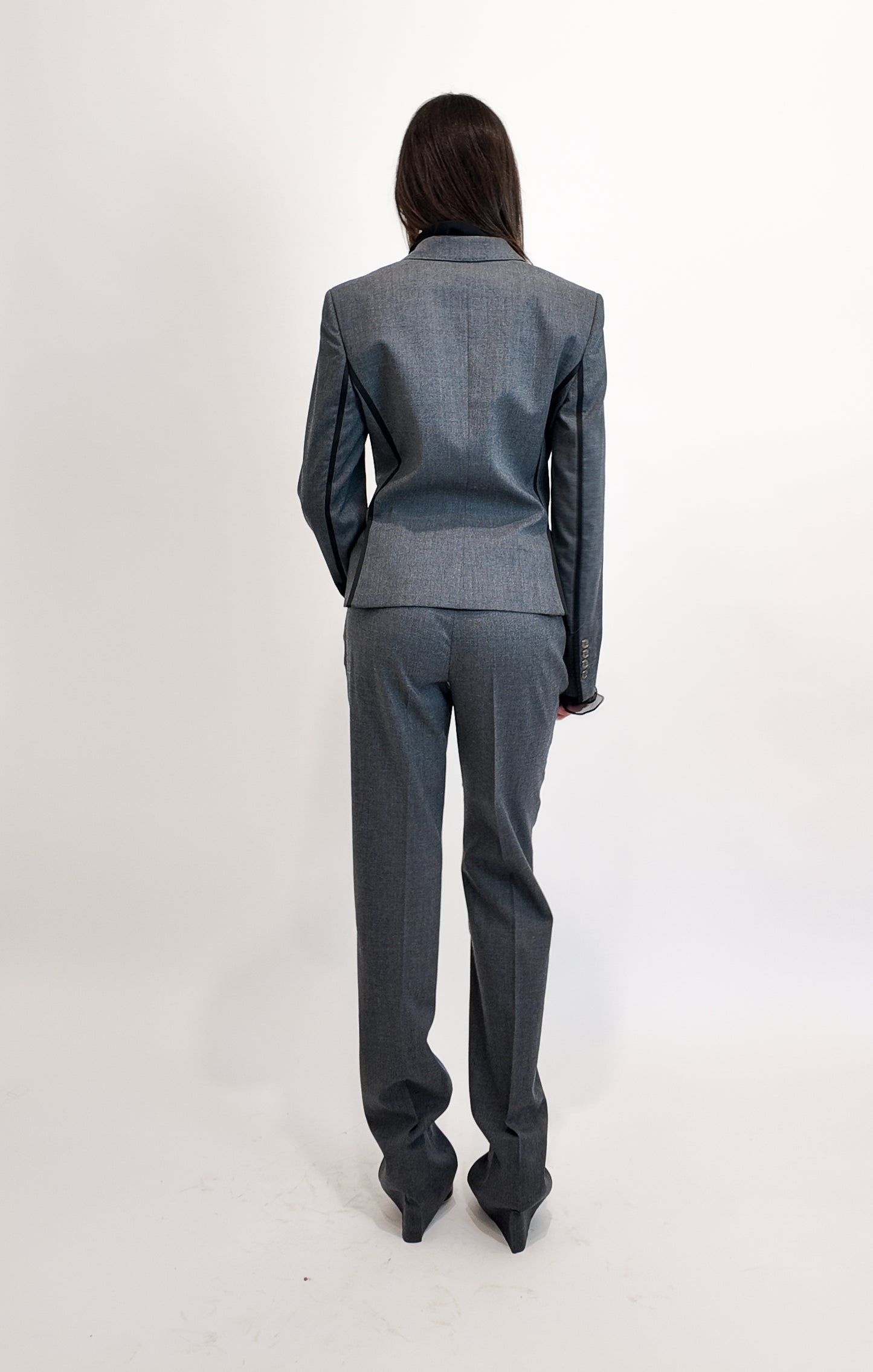 Person wearing a gray suit on a white background