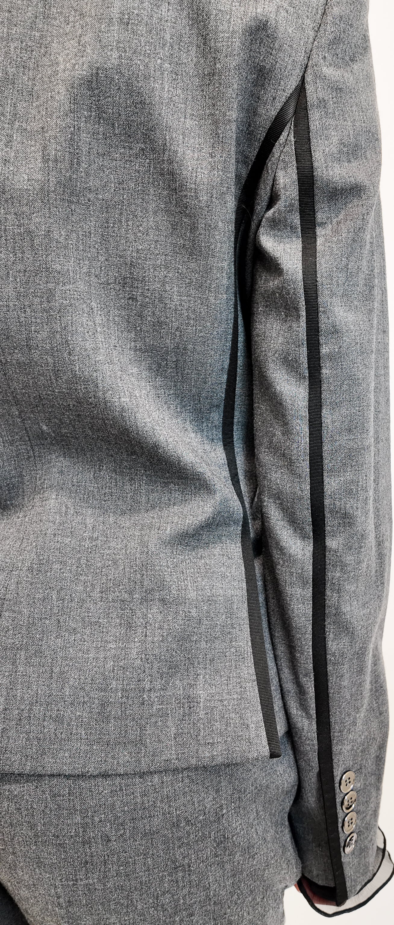 Gray suit jacket with black stripe on a white background
