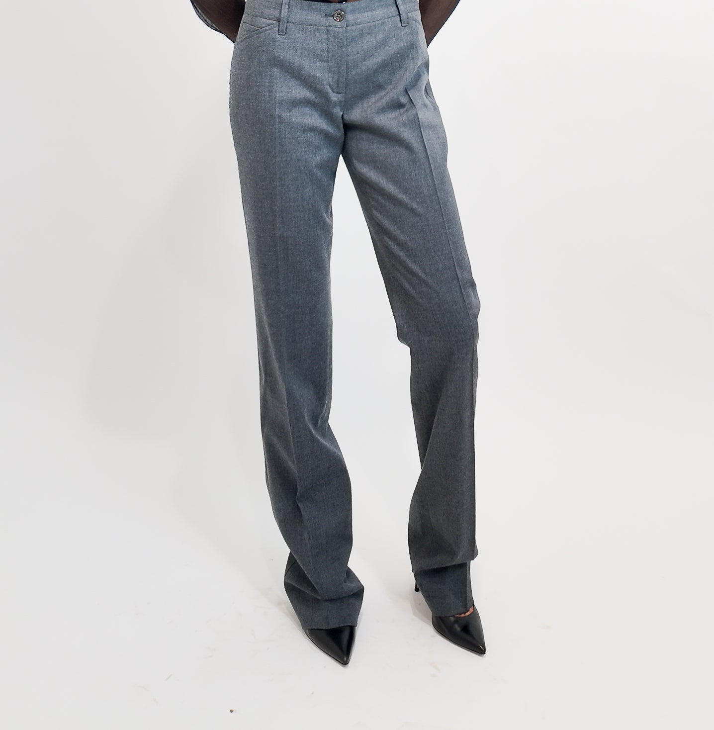 Gray pants worn by a person on a white background