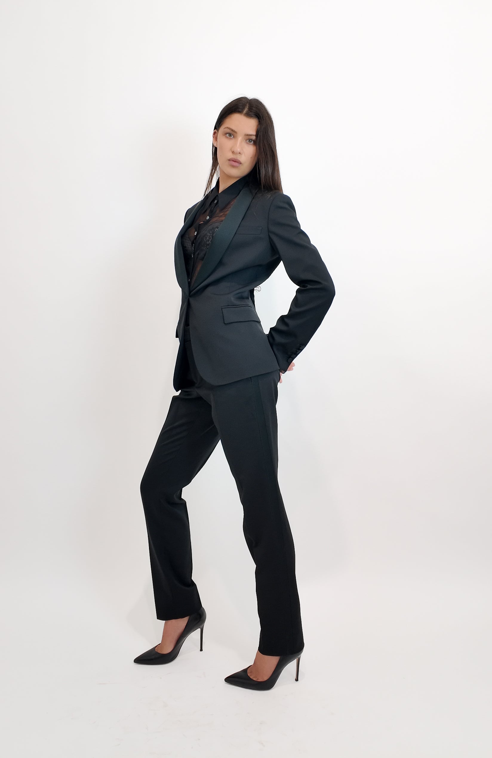 Woman wearing a black suit on a white background