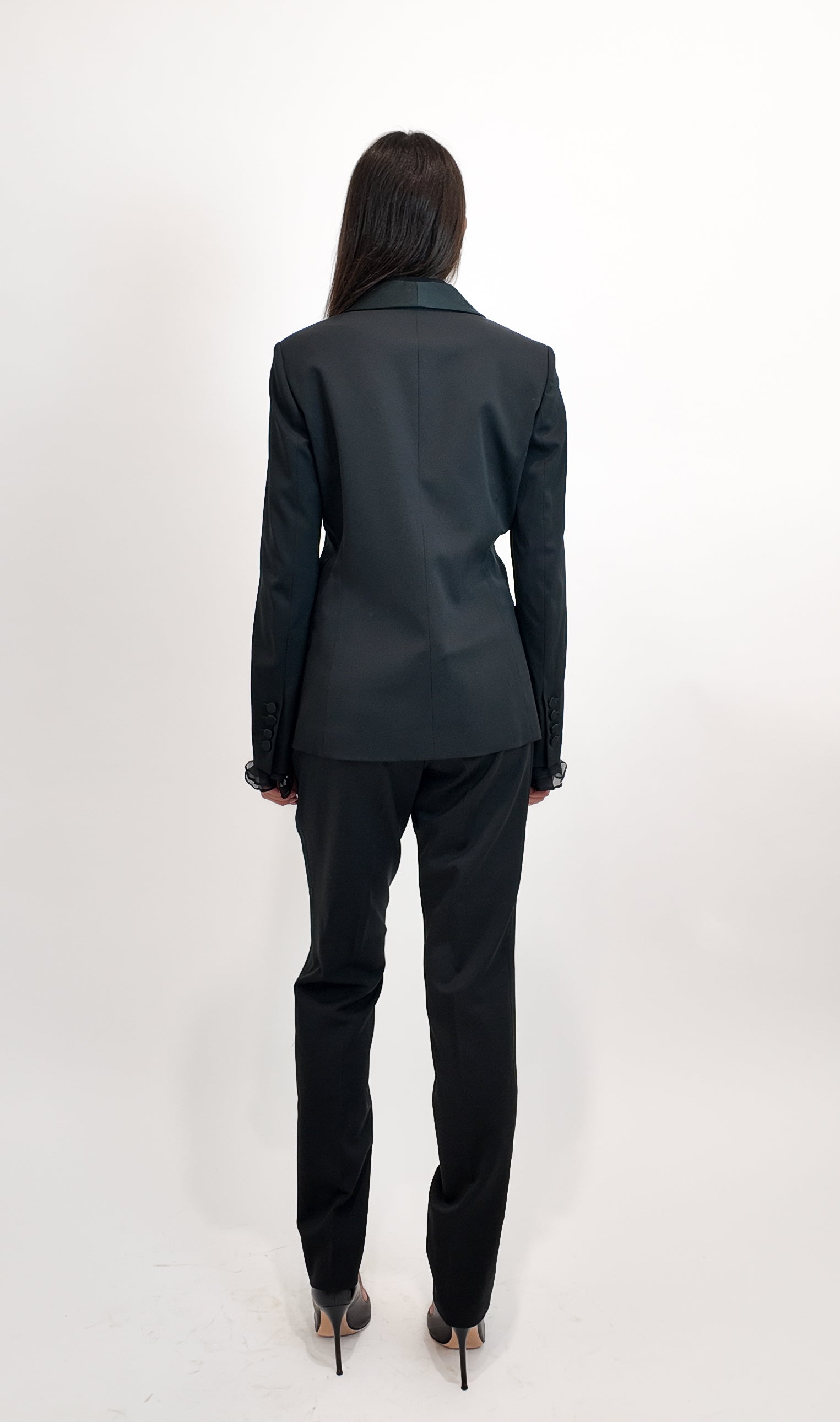 Person wearing a black suit on a white background