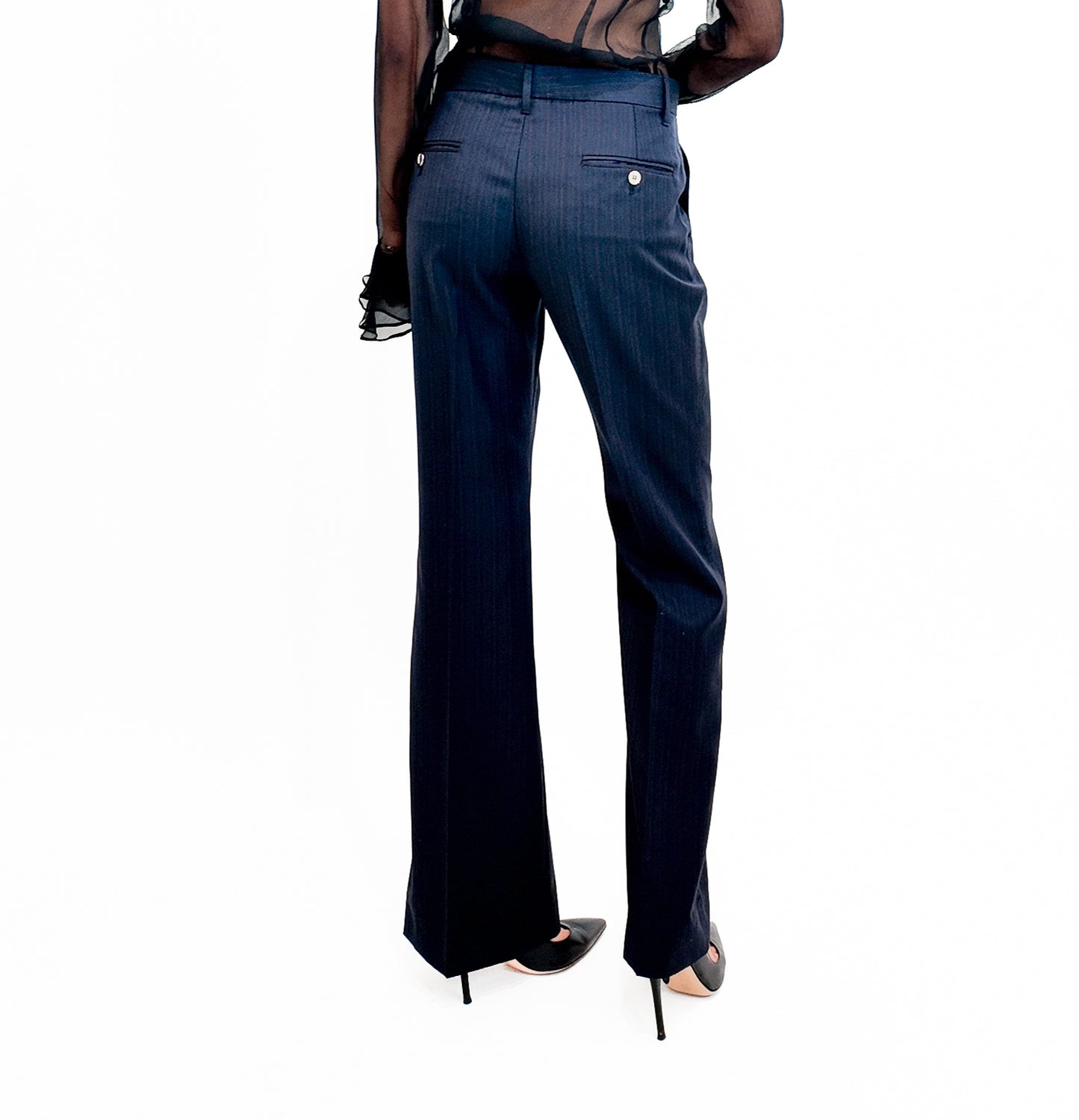 Navy blue pants worn by a person on a white background