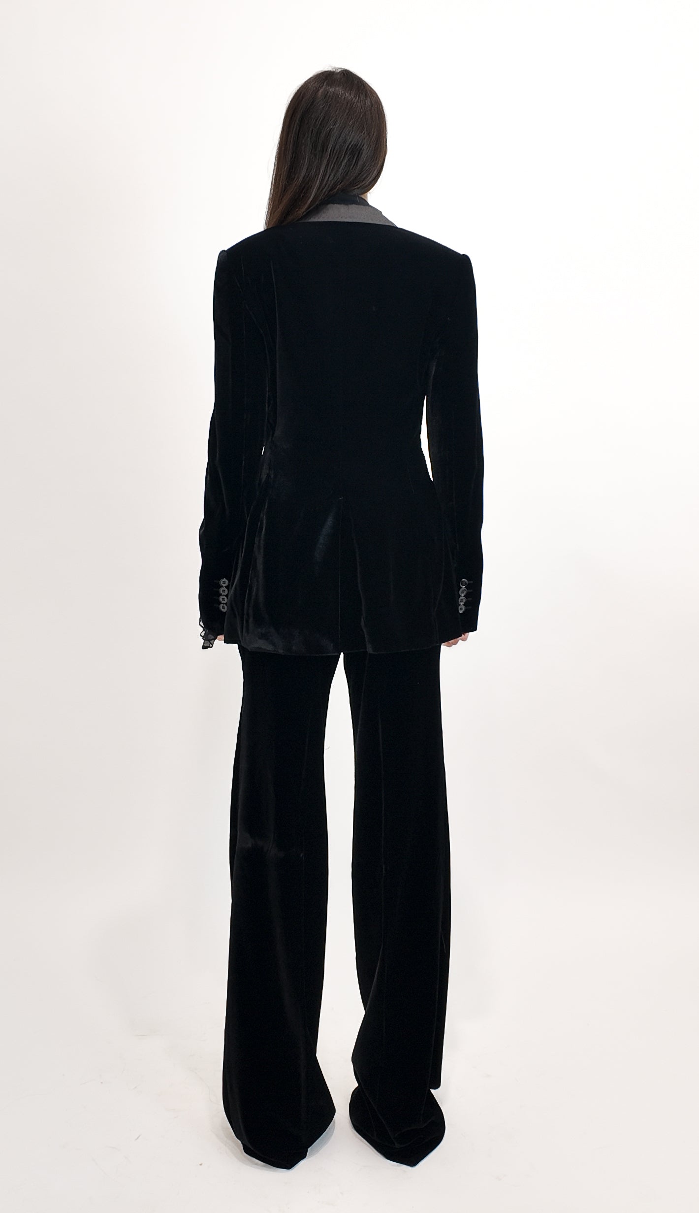 Person wearing a black suit on a white background