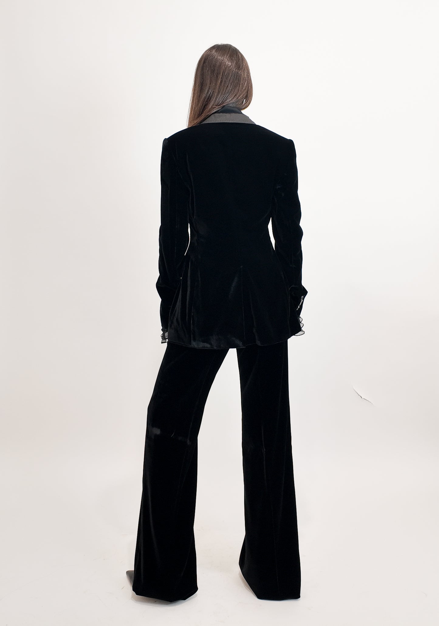 Person wearing a black suit on a white background