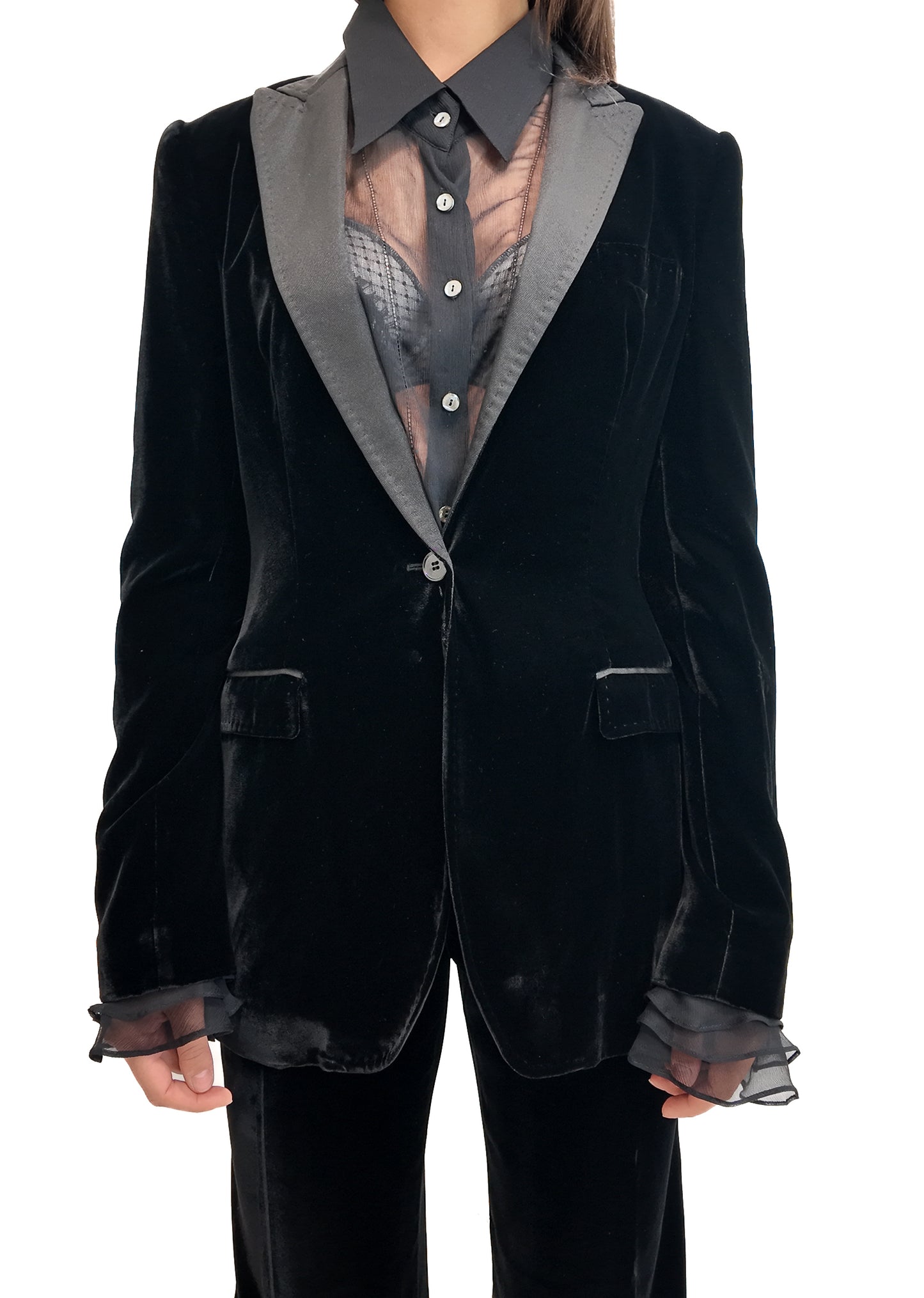 Black velvet suit with sheer details on a white background