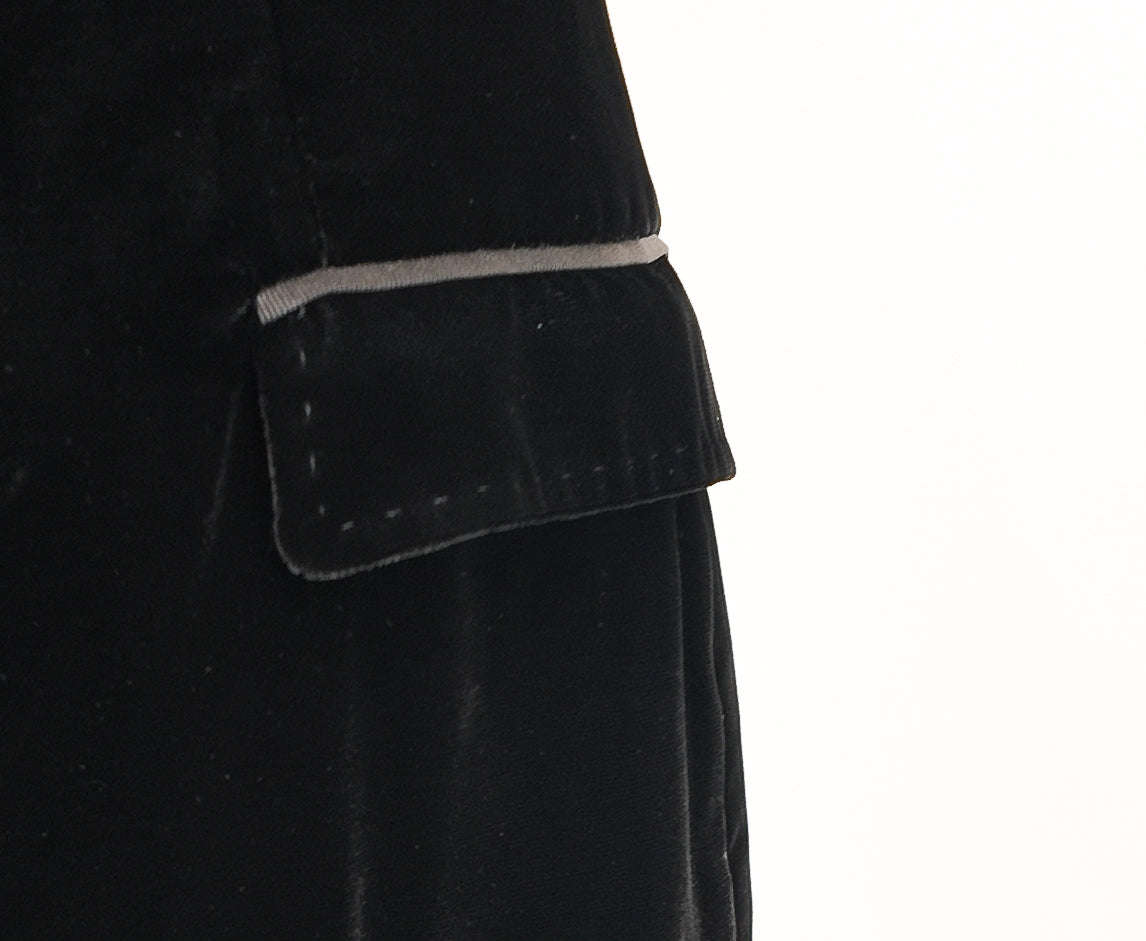 Close-up of a black coat with a pocket on a white background