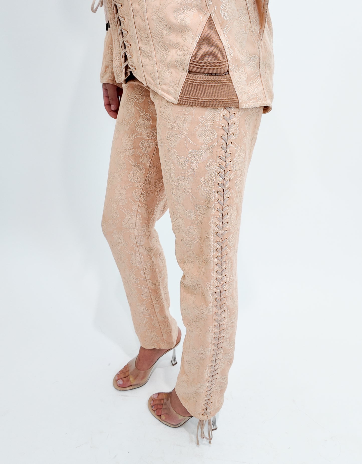Nude lace-up pants worn by a person on a white background