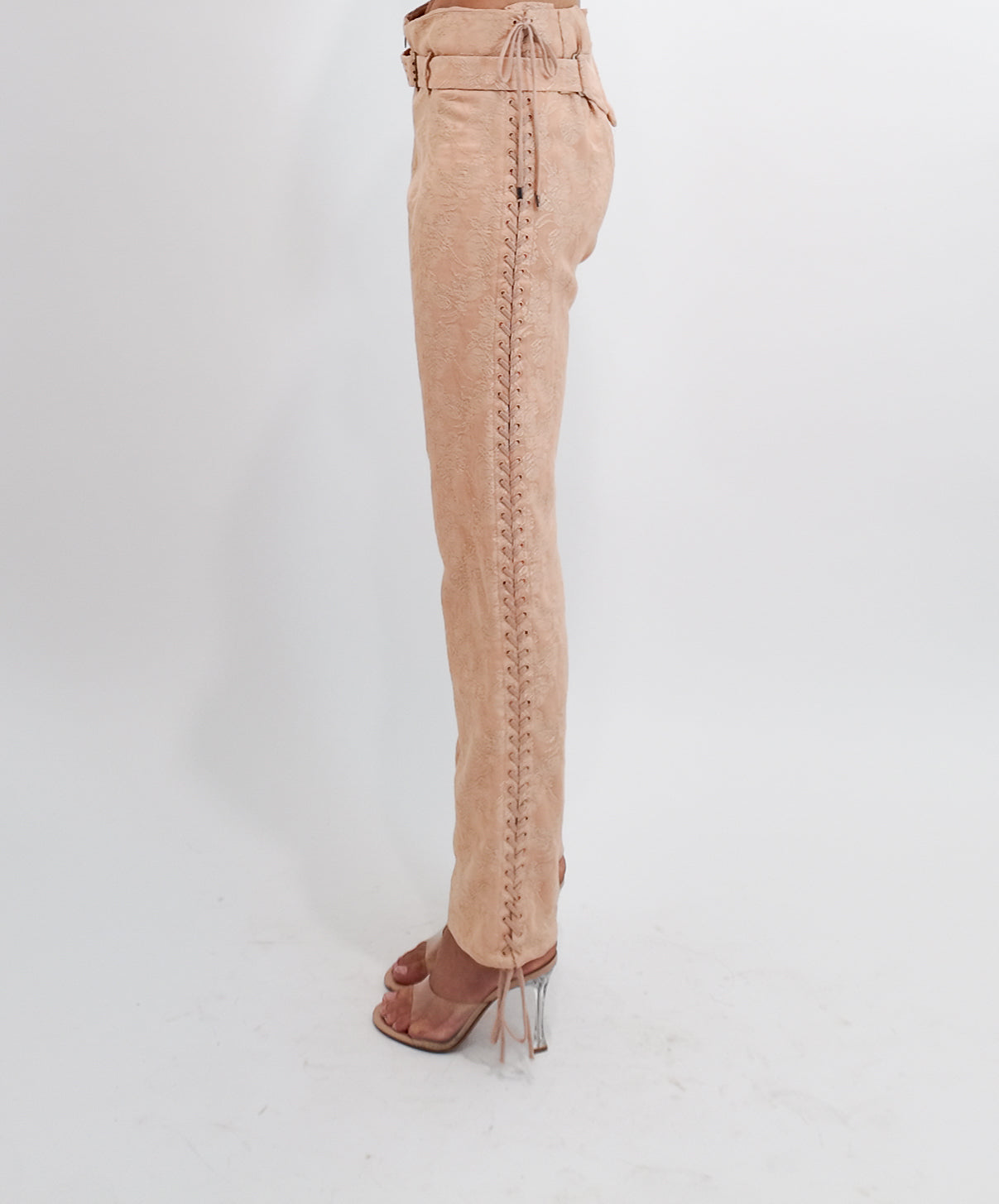 Nude pants with lace-up sides on a white background