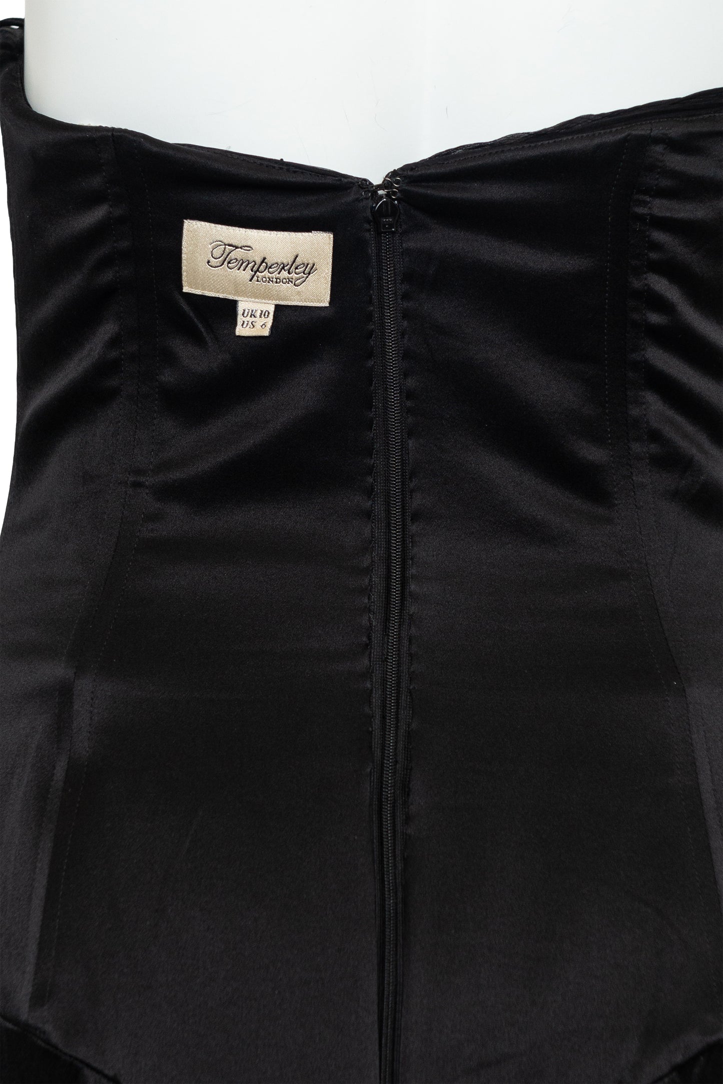 Black garment with a brand label on a white background