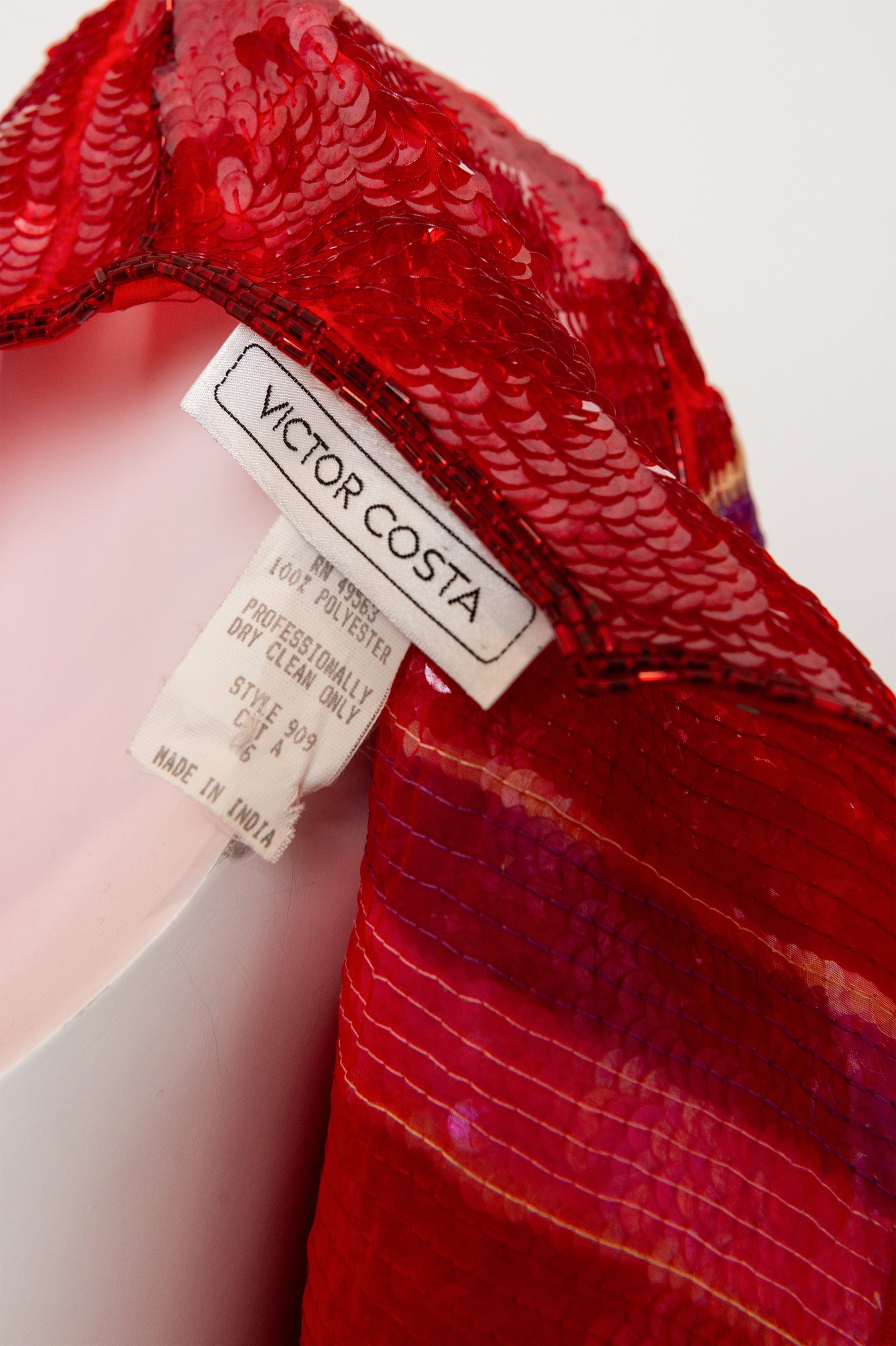 Red sequin dress with a visible 'Victor Costa' label on a white background
