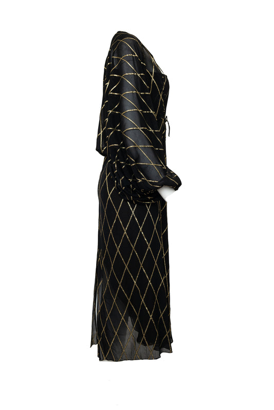 Black dress with gold geometric pattern on a white background