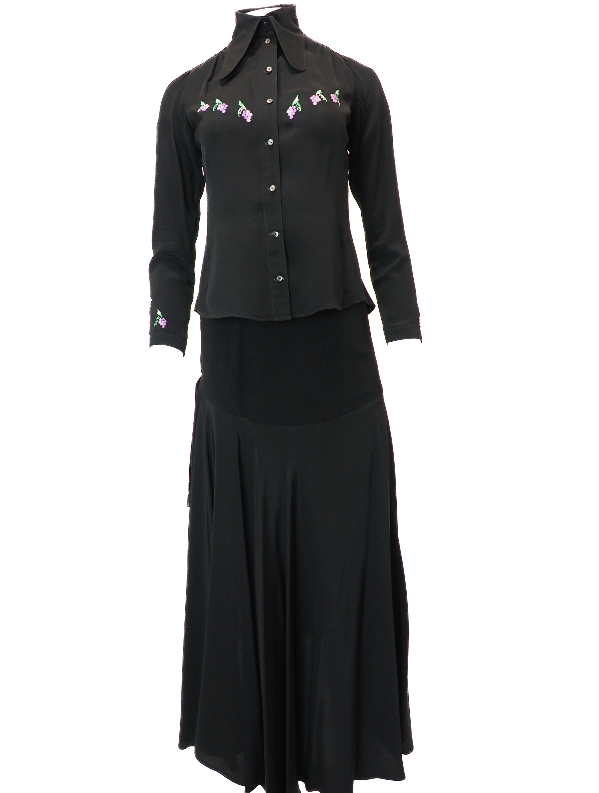 Black blouse with floral embroidery and black skirt on a white background