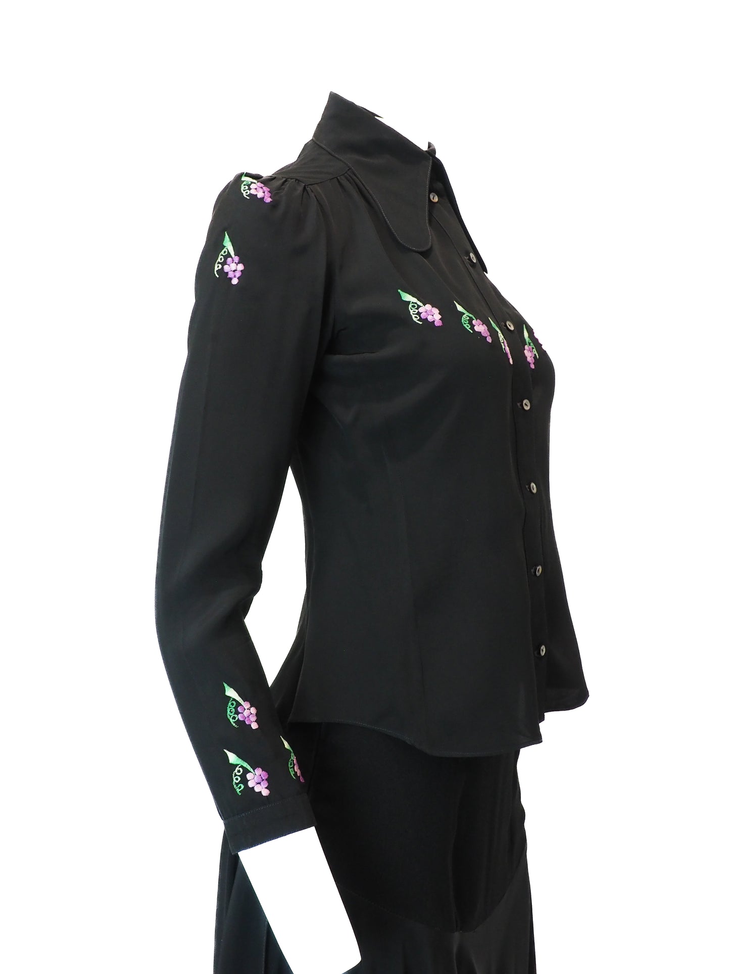 Black blouse with floral embroidery on a white background