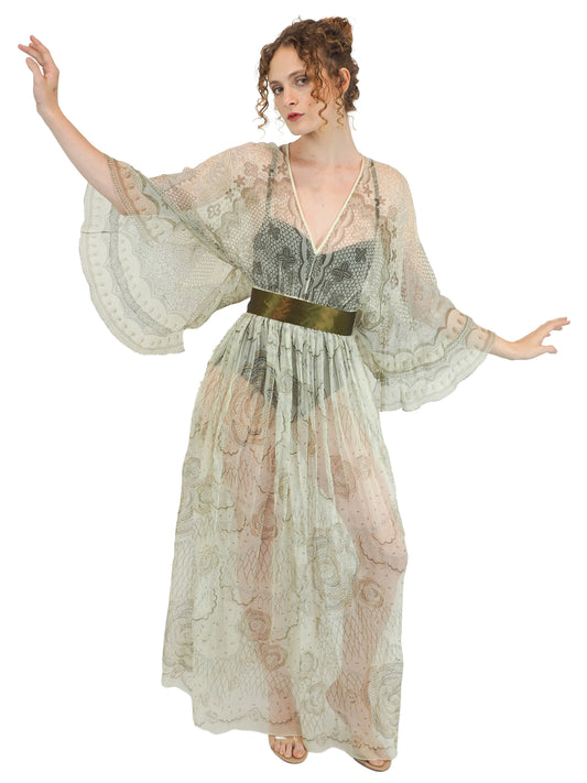 A vintage Zandra Rhodes long sheer maxi dress with a print detailing, wide three-quarter sleeves, and a wide dark olive green belt at the waist