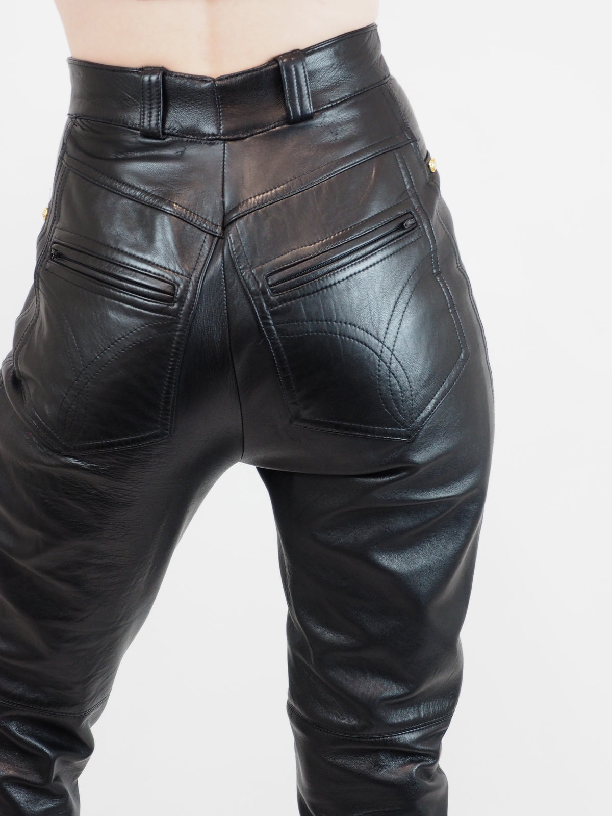 Vintage Black leather high-waisted slim-fit pants with side slits at the ankles