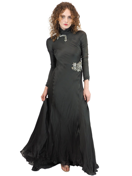 A vintage Alberta Ferretti floor-length green turtleneck gown with long sleeves and silver embellished details on the chest and waist