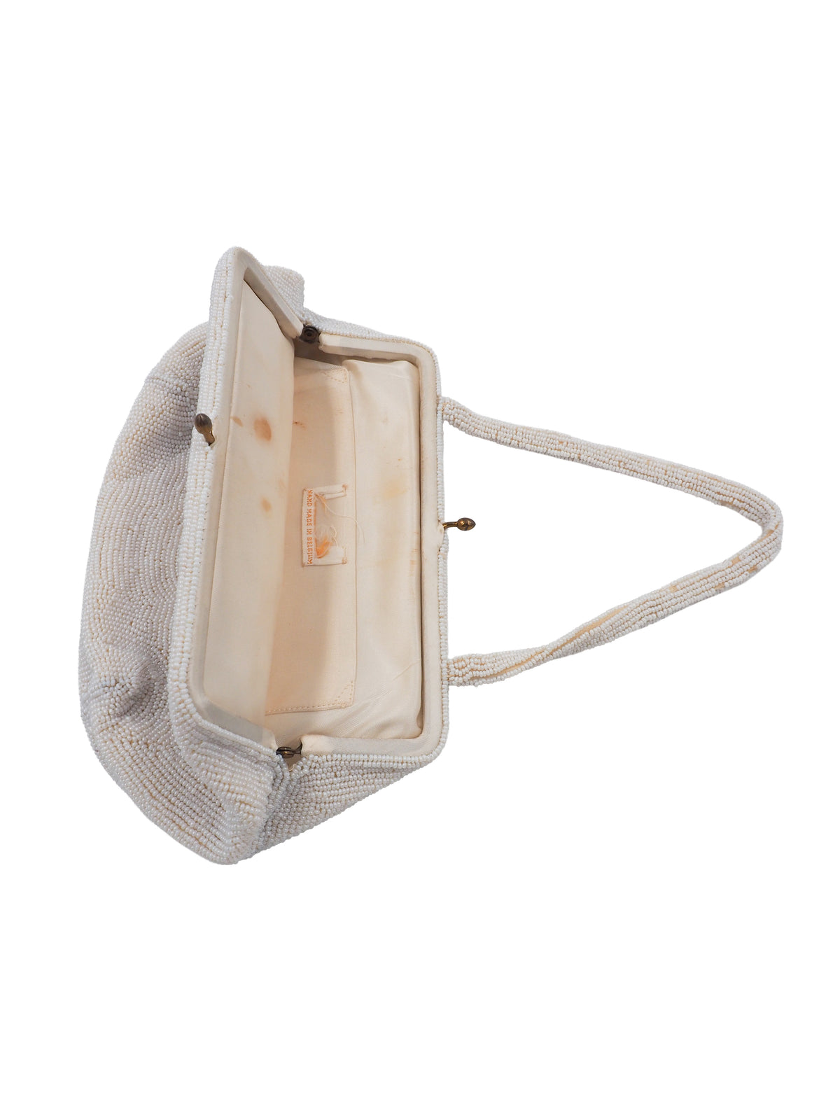 A vintage beaded handbag in a warm off-white/cream tone, featuring a floral embroidered pattern with pink, orange, and green details across the front, a small gold-tone clasp, and shoulder straps.
