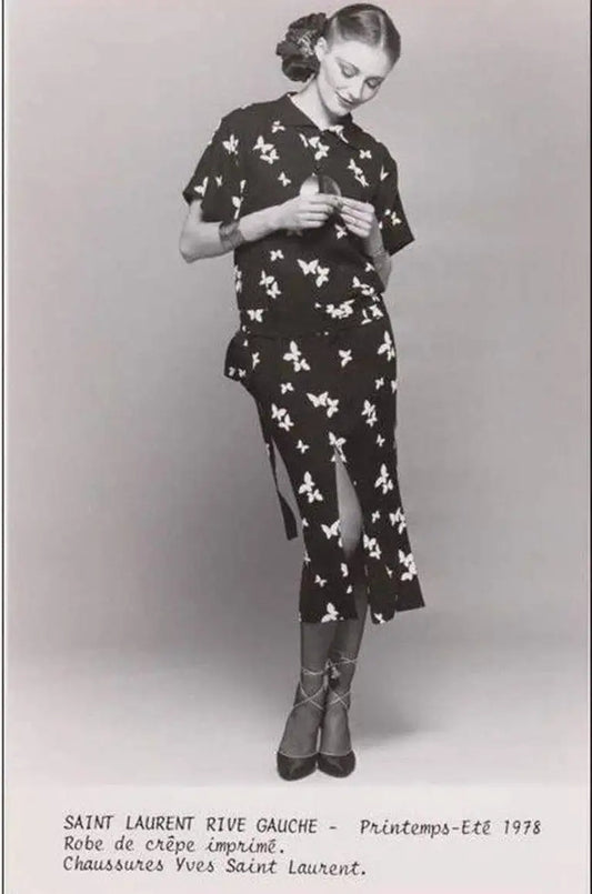 A vintage Yves Saint Laurent YSL 1970's black short-sleeve midi dress with a white bird pattern