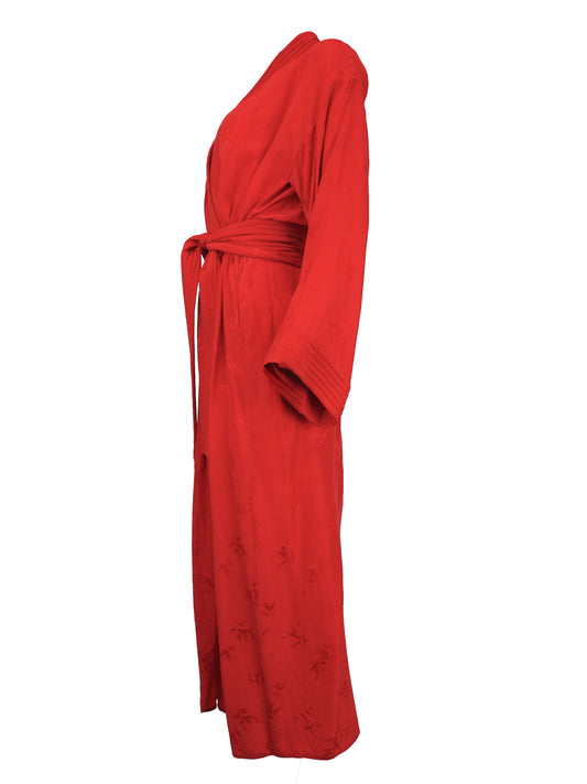 A vibrant red wrap robe with a matching waist tie belt, featuring a subtle tonal floral jacquard pattern near the lower hem