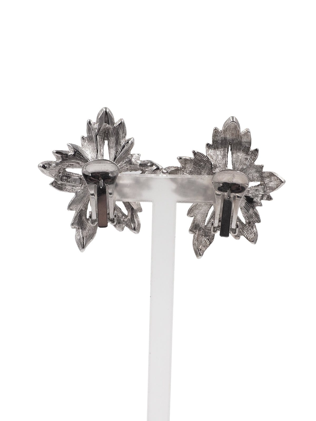 A pair of silver-toned leaf-shaped earrings with a central white pearl and pavé-set dark stones