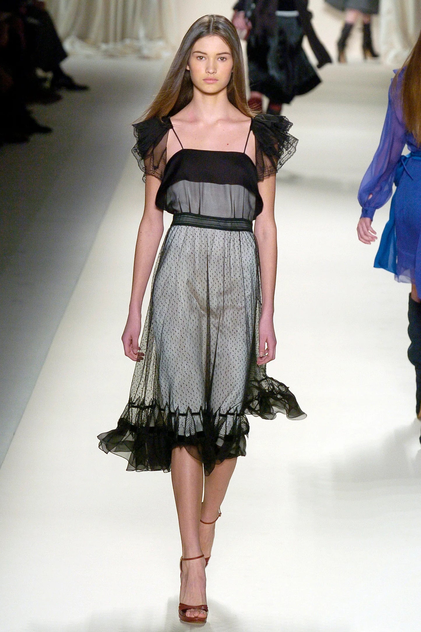 A vintage Chloe 2005 black sheer mesh dress with a solid black off-the-shoulder yoke, a polka-dotted tulle skirt, and ruffled trim details