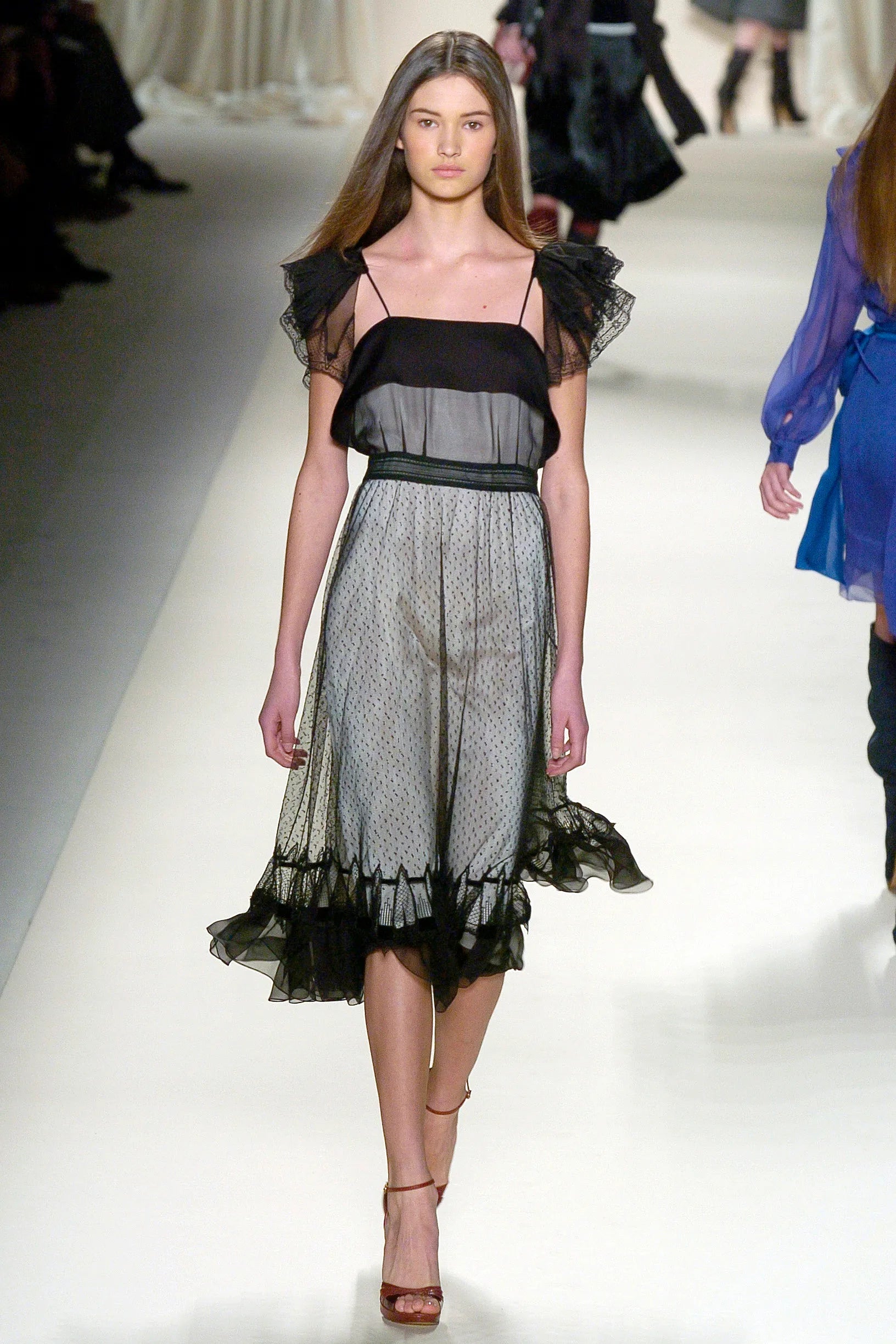 A vintage Chloe 2005 black sheer mesh dress with a solid black off-the-shoulder yoke, a polka-dotted tulle skirt, and ruffled trim details