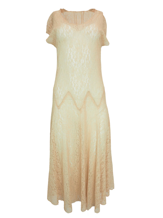 A vintage 1920s light beige lace maxi dress with short flutter sleeves, a scoop neckline, and a scalloped zigzag pattern around the waist