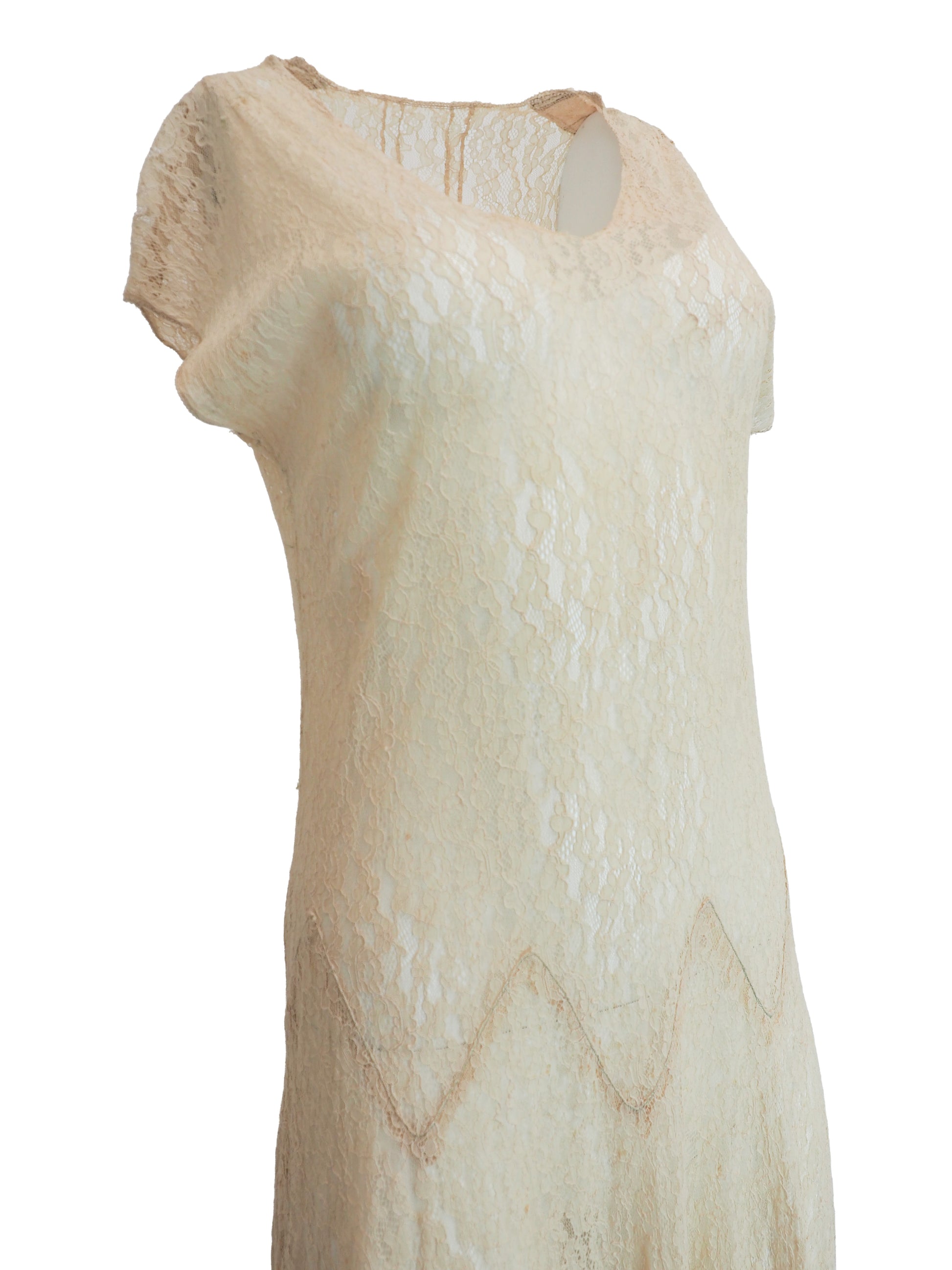 A vintage 1920s light beige lace maxi dress with short flutter sleeves, a scoop neckline, and a scalloped zigzag pattern around the waist