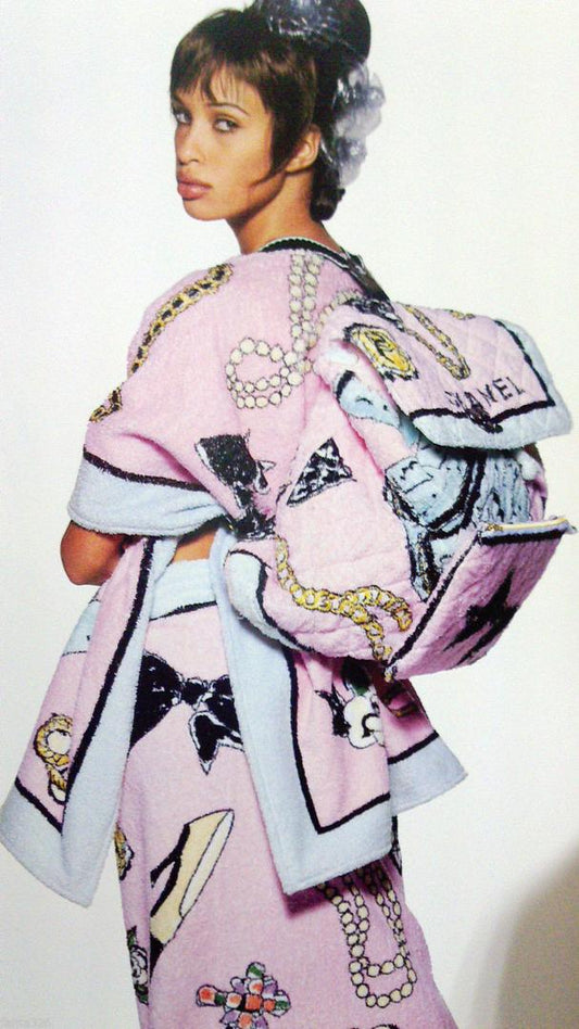 Model Brandi Quinones wearing a pink Chanel coat with graphic designs on a white background