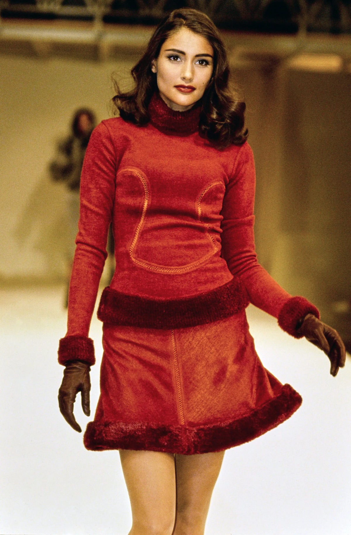 A vintage 1991 alaia black long-sleeve top and skirt set with a fuzzy collar and hem, featuring cut out seam curved trim details on the bodice and skirt