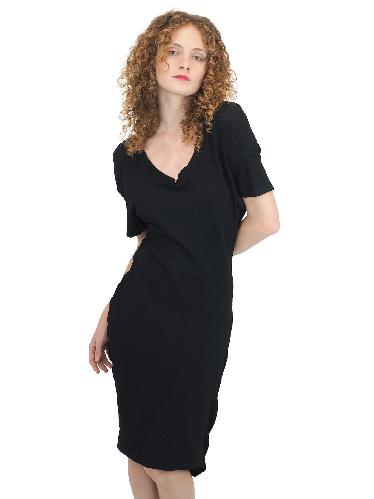 A vintage 1990s alaia black short-sleeve bodycon knit dress with back button details