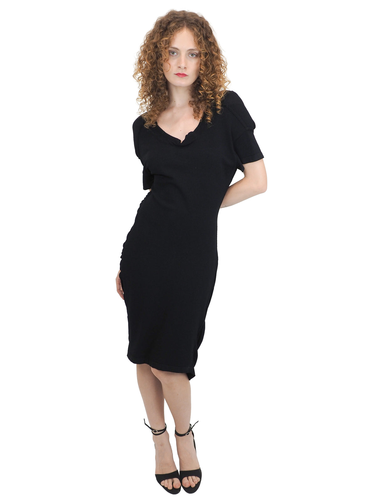 A vintage 1990s alaia black short-sleeve bodycon knit dress with back button details