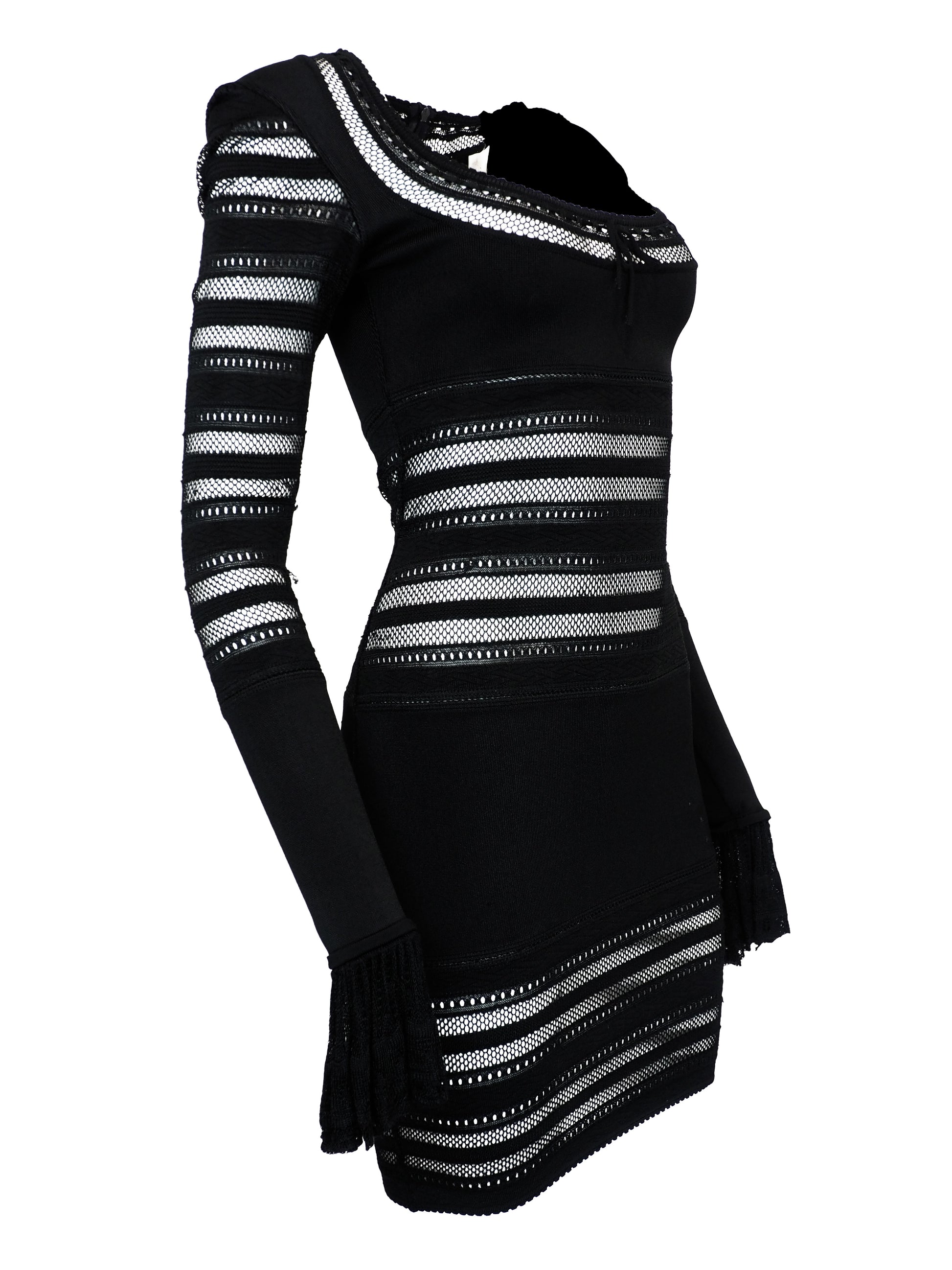 A vintage alaia 1993 black long-sleeve knit mini dress with horizontal openwork stripe patterns across the bodice, sleeves, and hem, featuring a scoop neckline with a front tie detail.