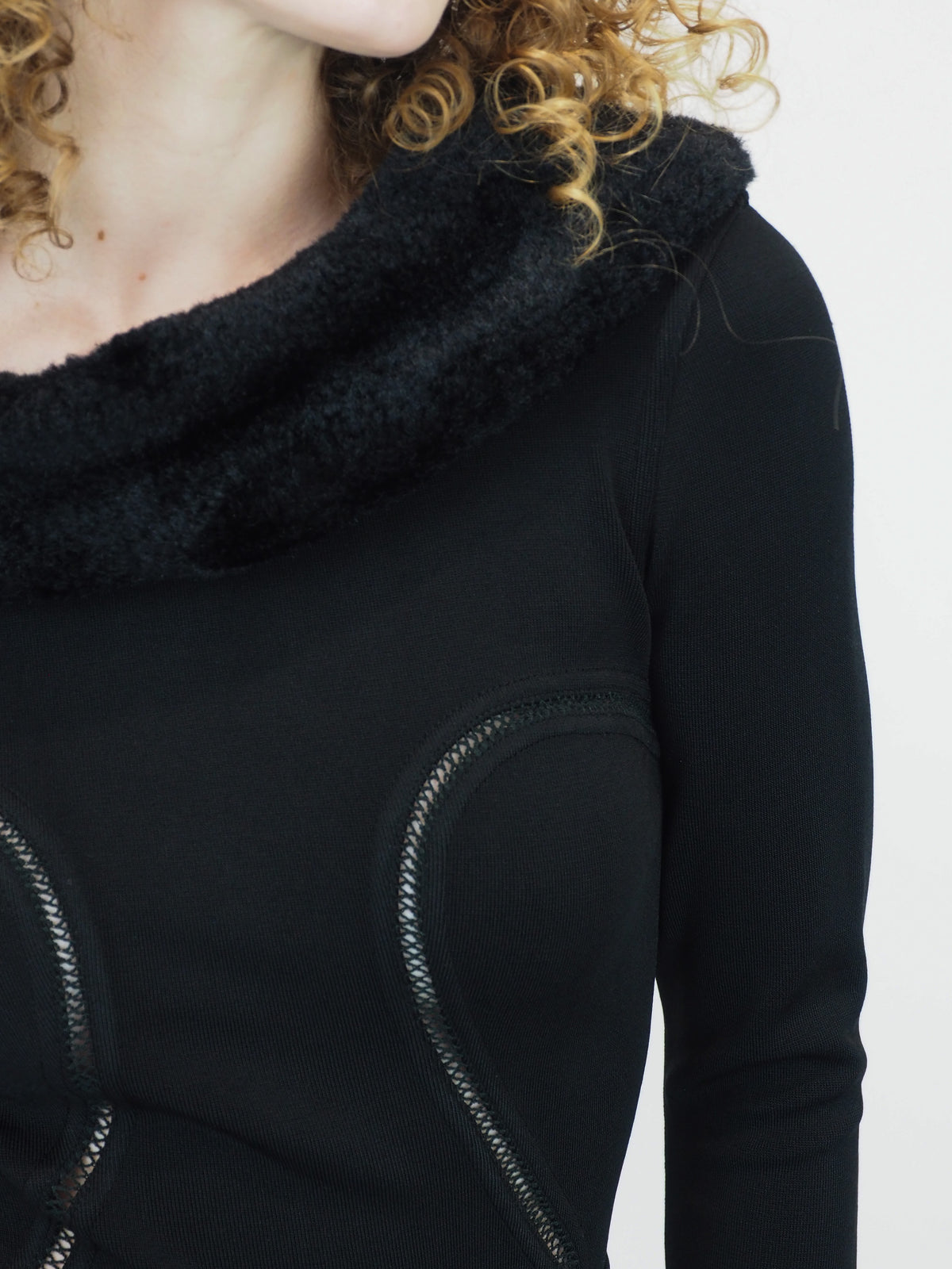 A vintage 1991 alaia black long-sleeve top and skirt set with a fuzzy collar and hem, featuring cut out seam curved trim details on the bodice and skirt