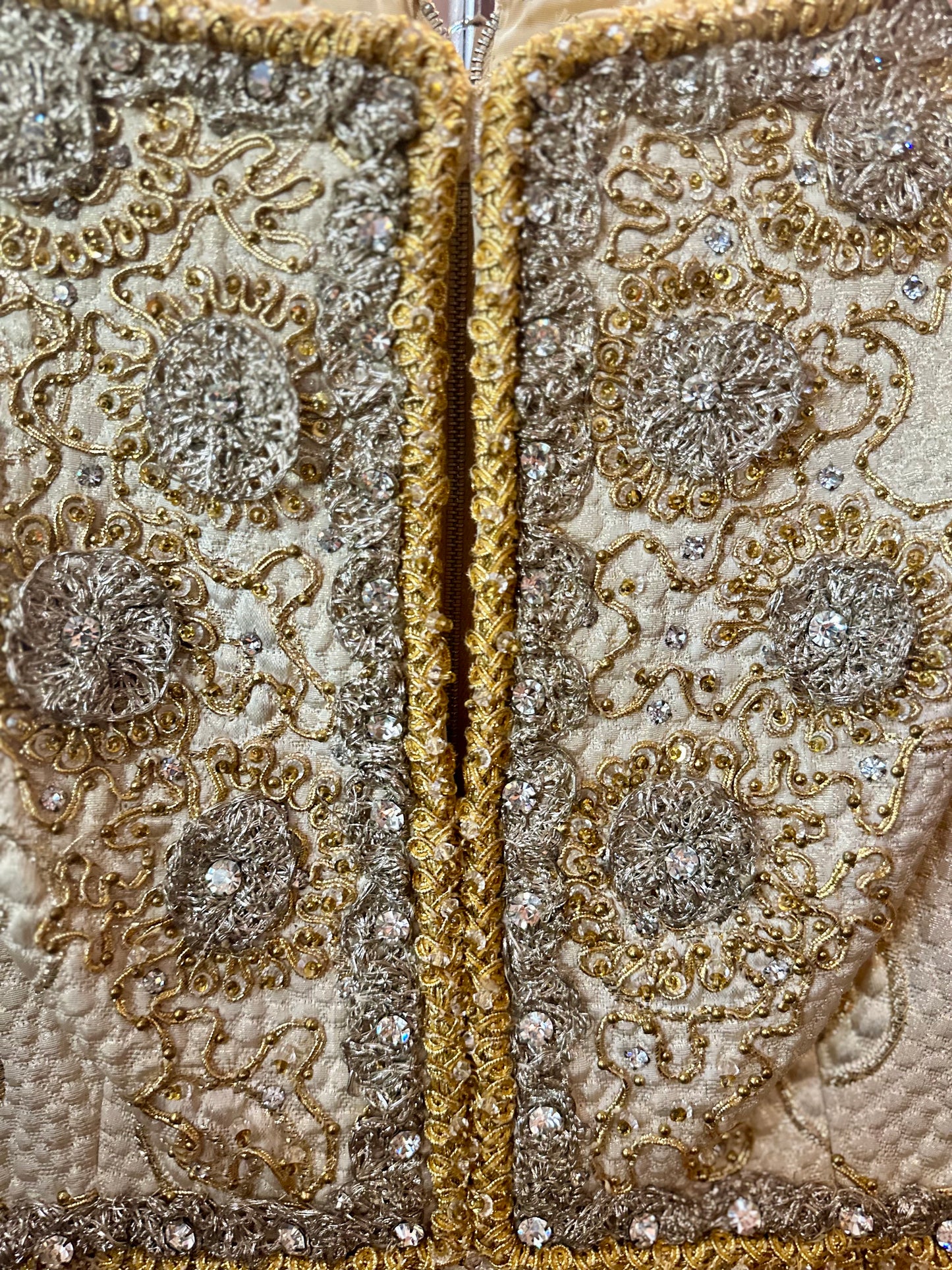 Close-up of intricately designed fabric with gold and silver patterns