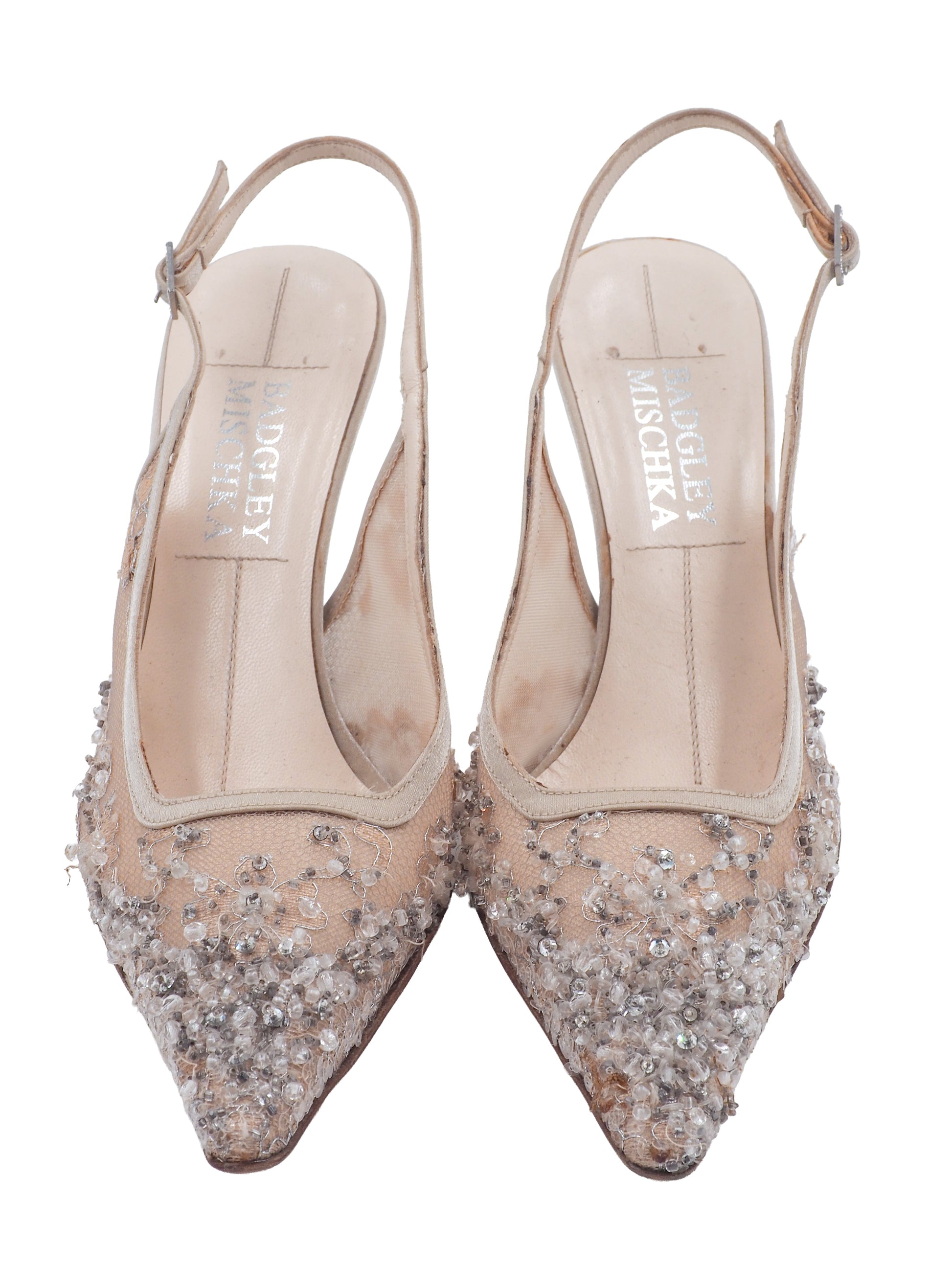 A vintage pair of Badgley Mischka pointed-toe slingback heels in sheer nude lace with dense crystal embellishments, shown on a plain white background.