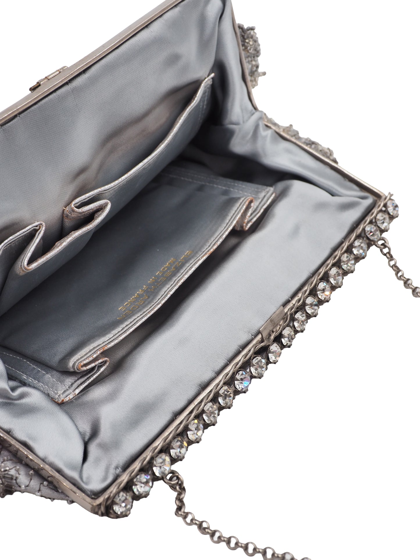 A vintage Elizabeth Arden silver-gray beaded evening clutch bag with a chain strap and a decorative crystal-embellished clasp