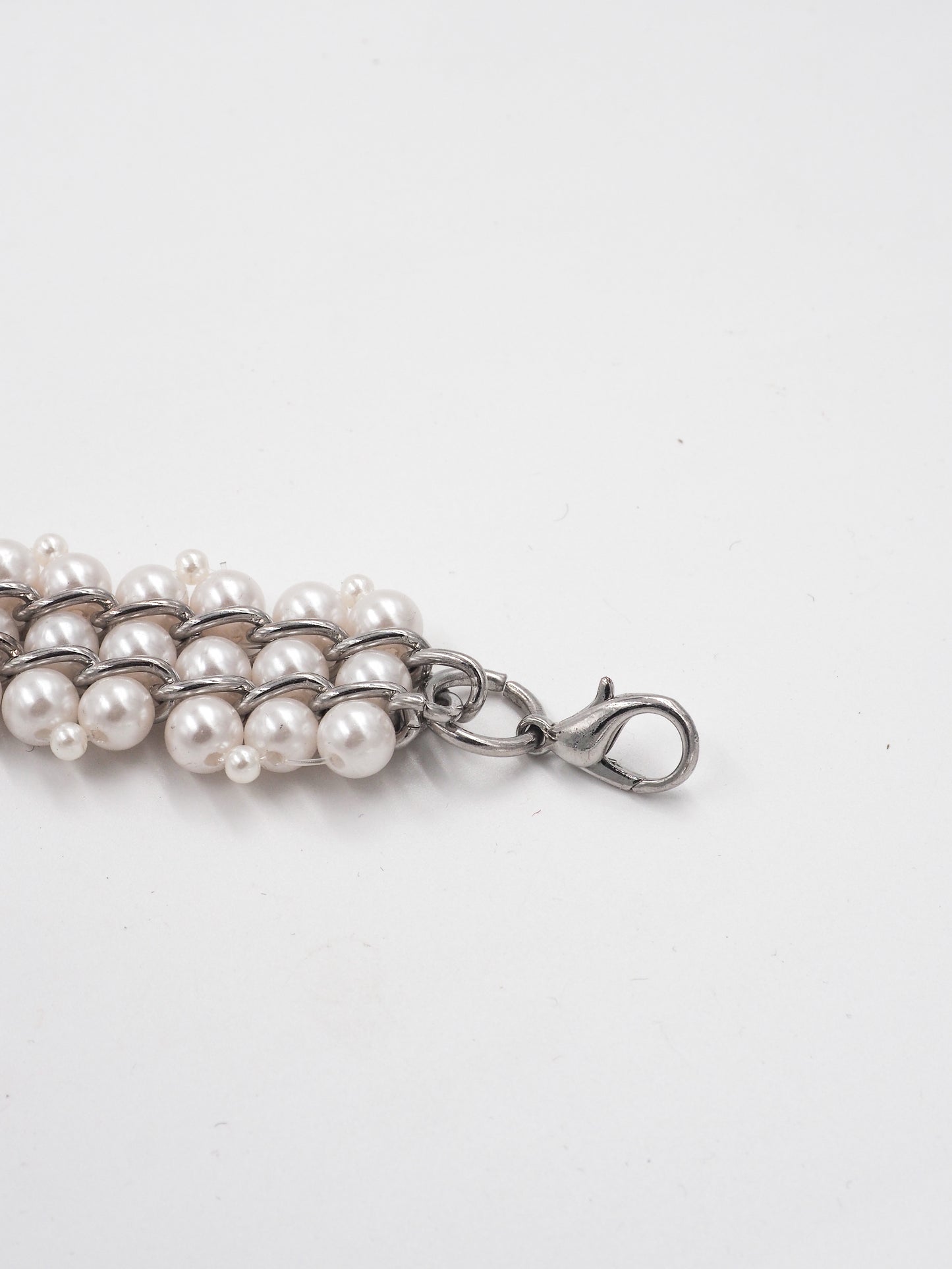 A vintage multi-strand pearl belt with a silver-tone chain extender clasp