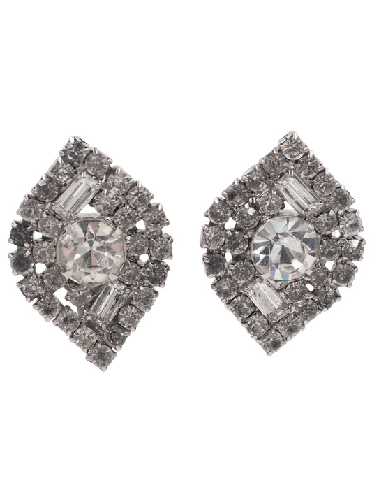 A pair of vintage costume diamond stud earrings with a central round brilliant-cut diamond surrounded by baguette and round-cut diamonds in a shield-like setting 