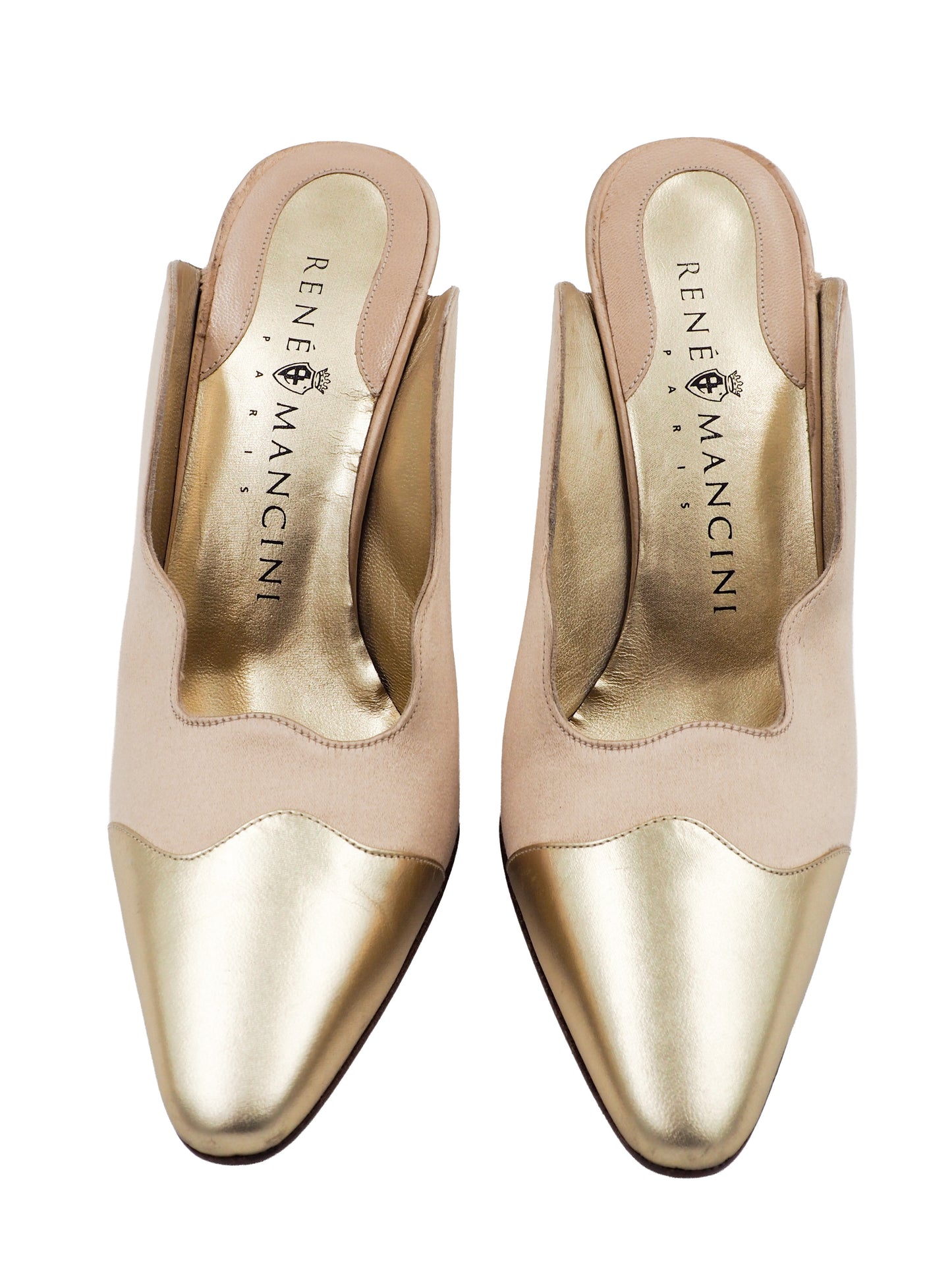 A vintage pair of pointed-toe mule heels in metallic champagne gold and beige, featuring a scalloped edge detail and a slim high heel