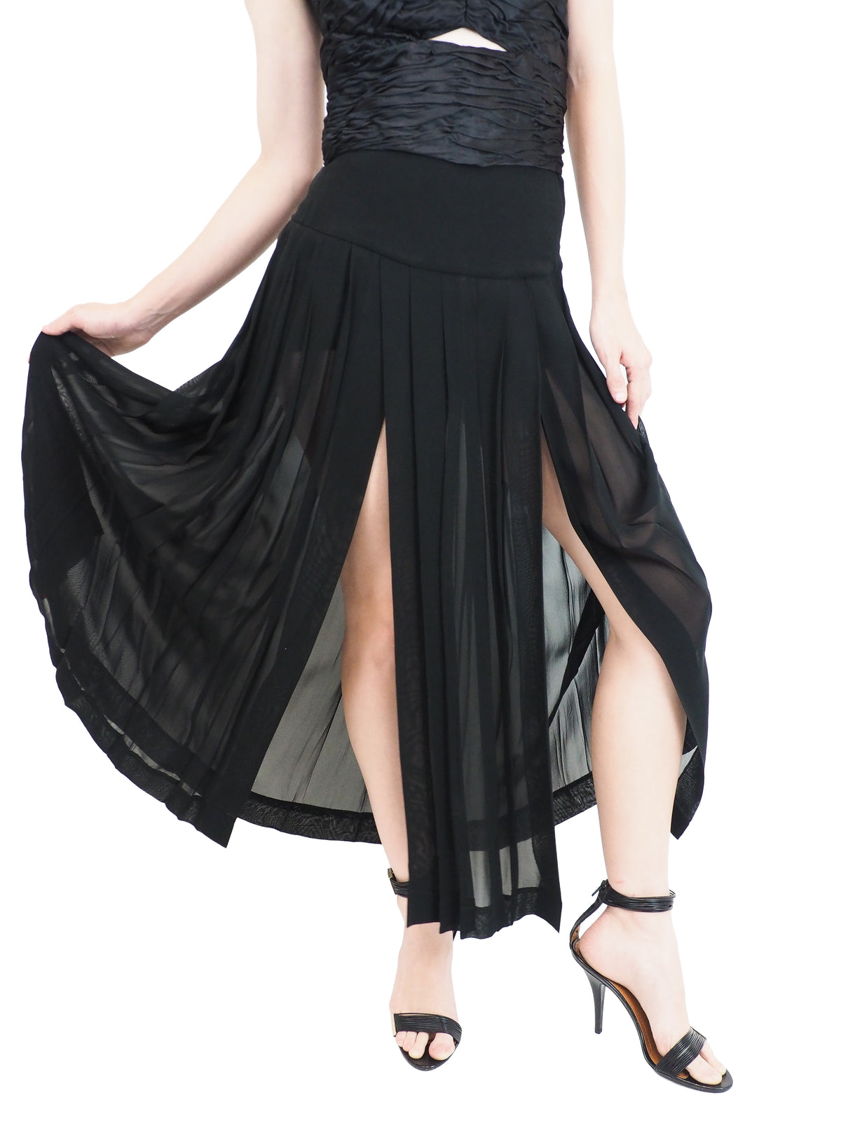 A vintage moschino black strapless high-low dress with a textured corset-style bodice, front cutout, and flowing sheer overlay skirt, paired with black heeled sandals