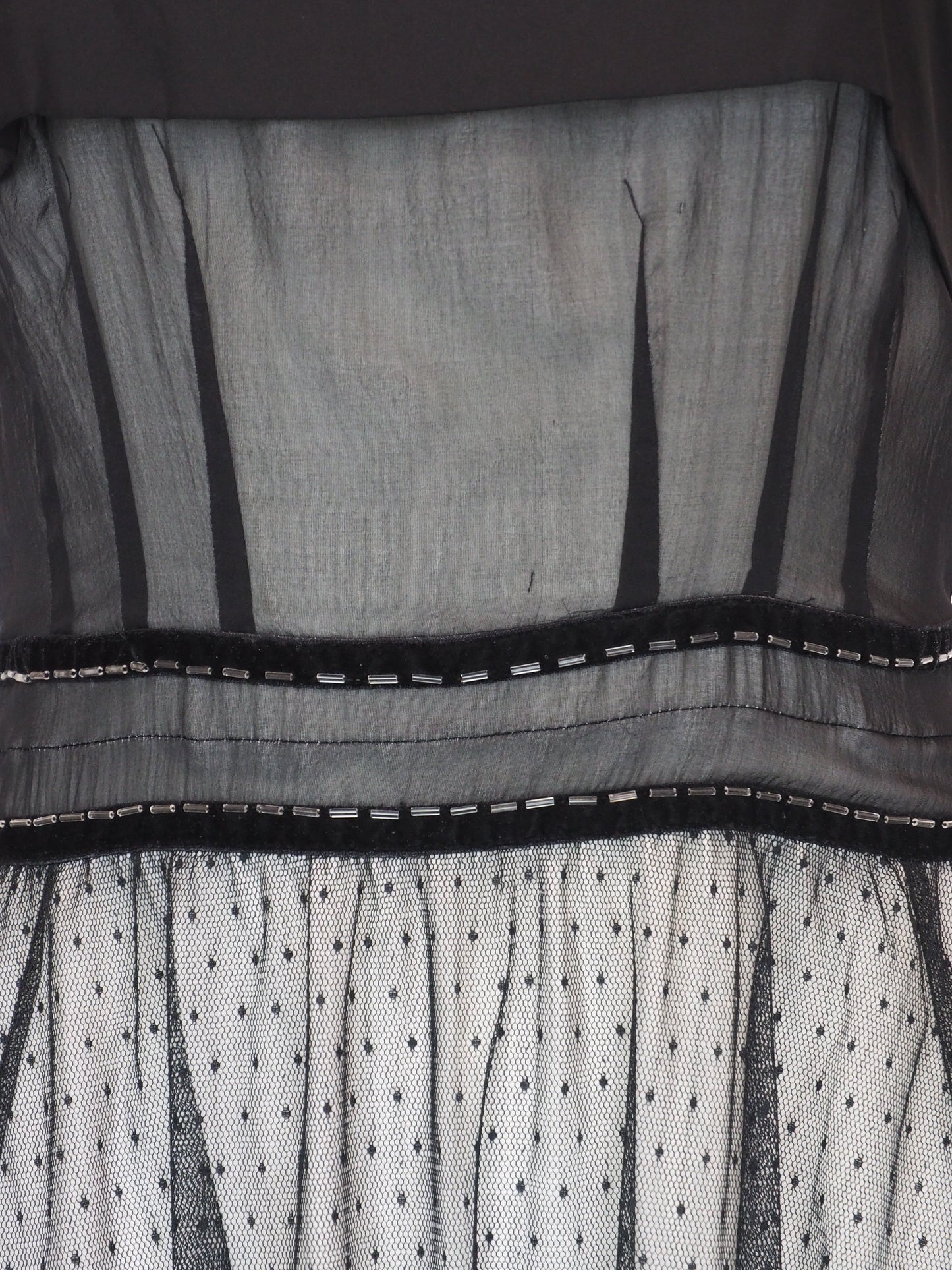 A vintage Chloe 2005 black sheer mesh dress with a solid black off-the-shoulder yoke, a polka-dotted tulle skirt, and ruffled trim details