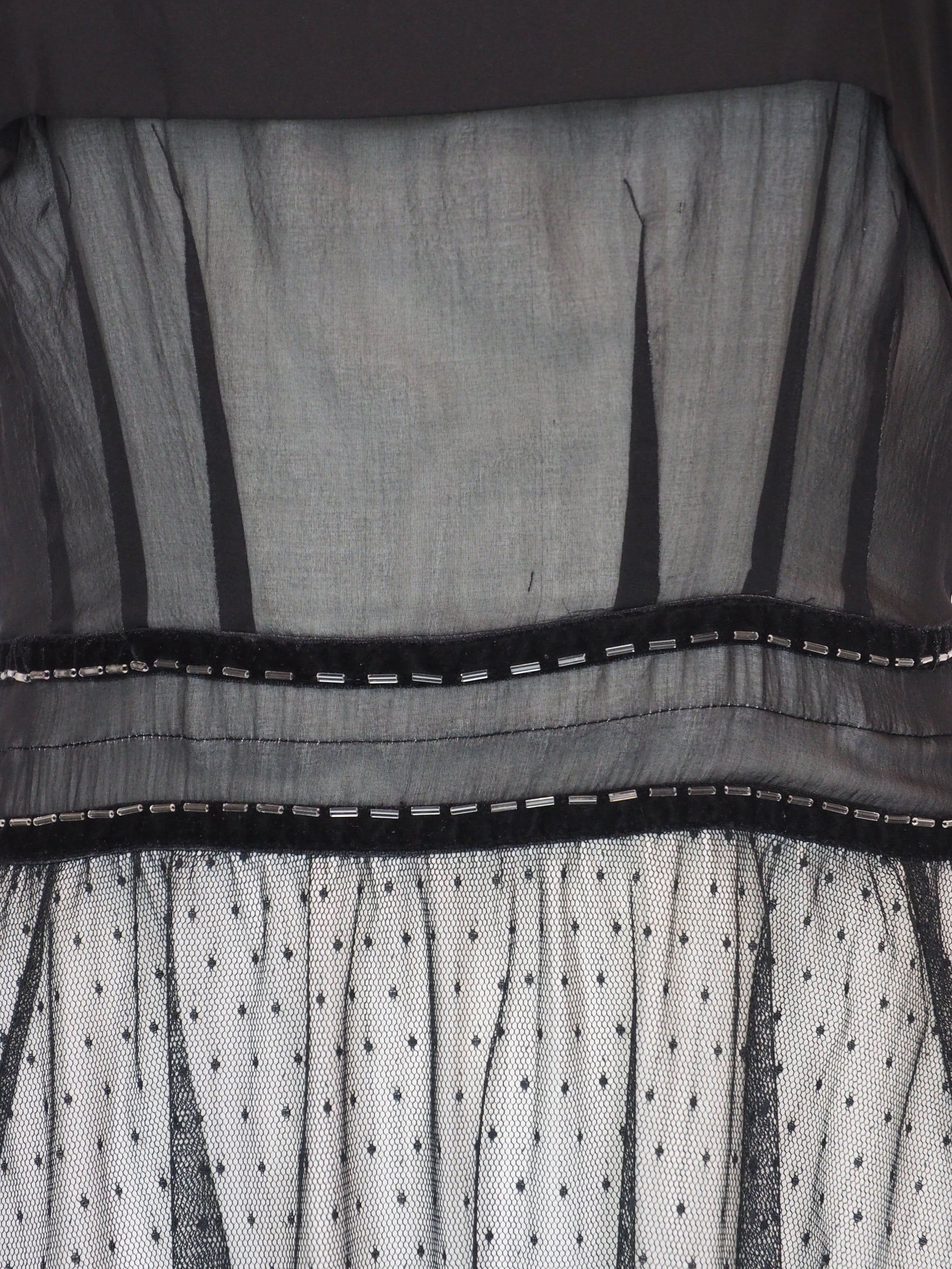 A vintage Chloe 2005 black sheer mesh dress with a solid black off-the-shoulder yoke, a polka-dotted tulle skirt, and ruffled trim details
